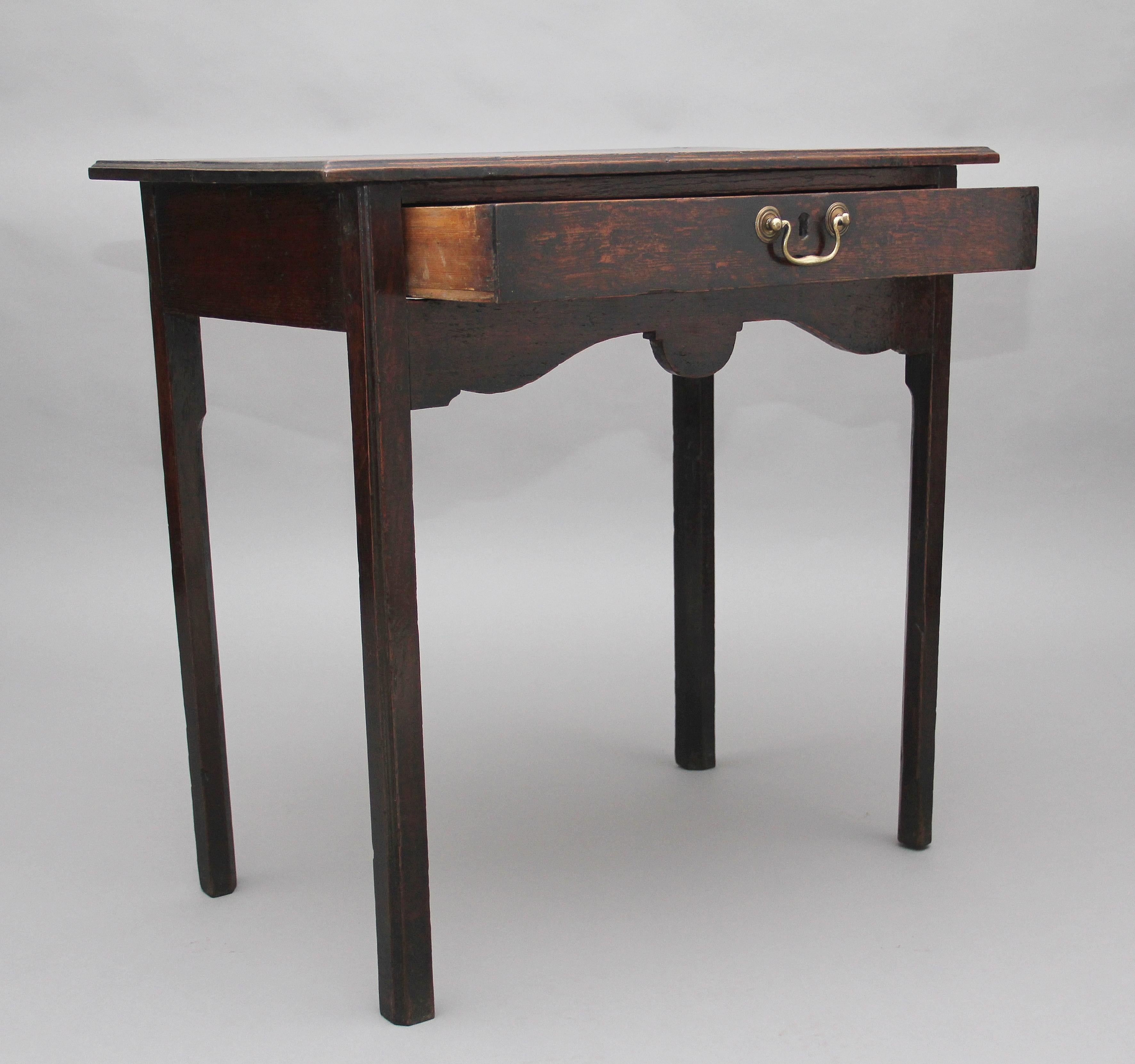 Early 19th century oak side table, the moulded edge top above a drawer with a brass swan neck handle, shaped apron, supported on square legs, circa 1820.

    