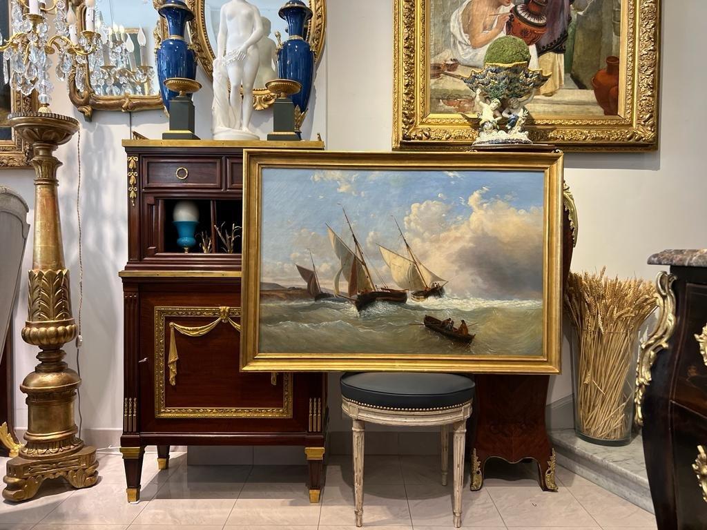 We present you this rare and stunning marine oil painting dating back from the early 19th century. The painting captures a lively scene from Villerville, a coastal town in the French department of Calvados, as flat-bottomed boats, known as