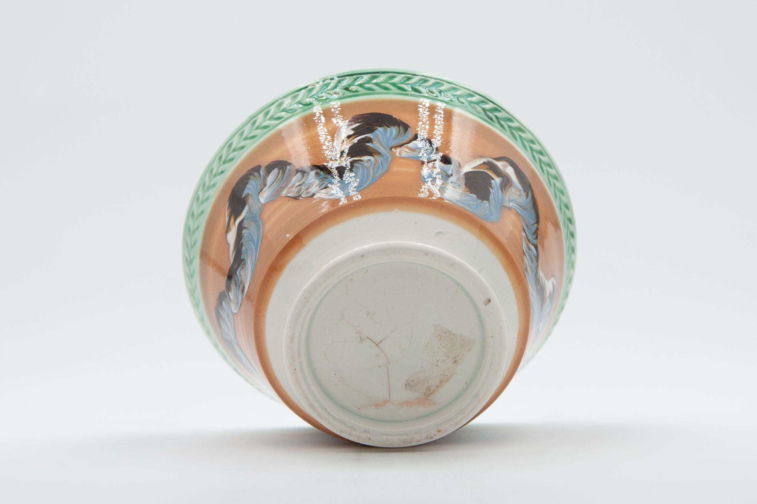 An English mochaware waste bowl in the London shape with cable or “earthworm” decoration, dating to circa 1820.

Developed in Staffordshire in the late 18th century, dipped wares utilized colored liquid clay slips to create surprisingly modern