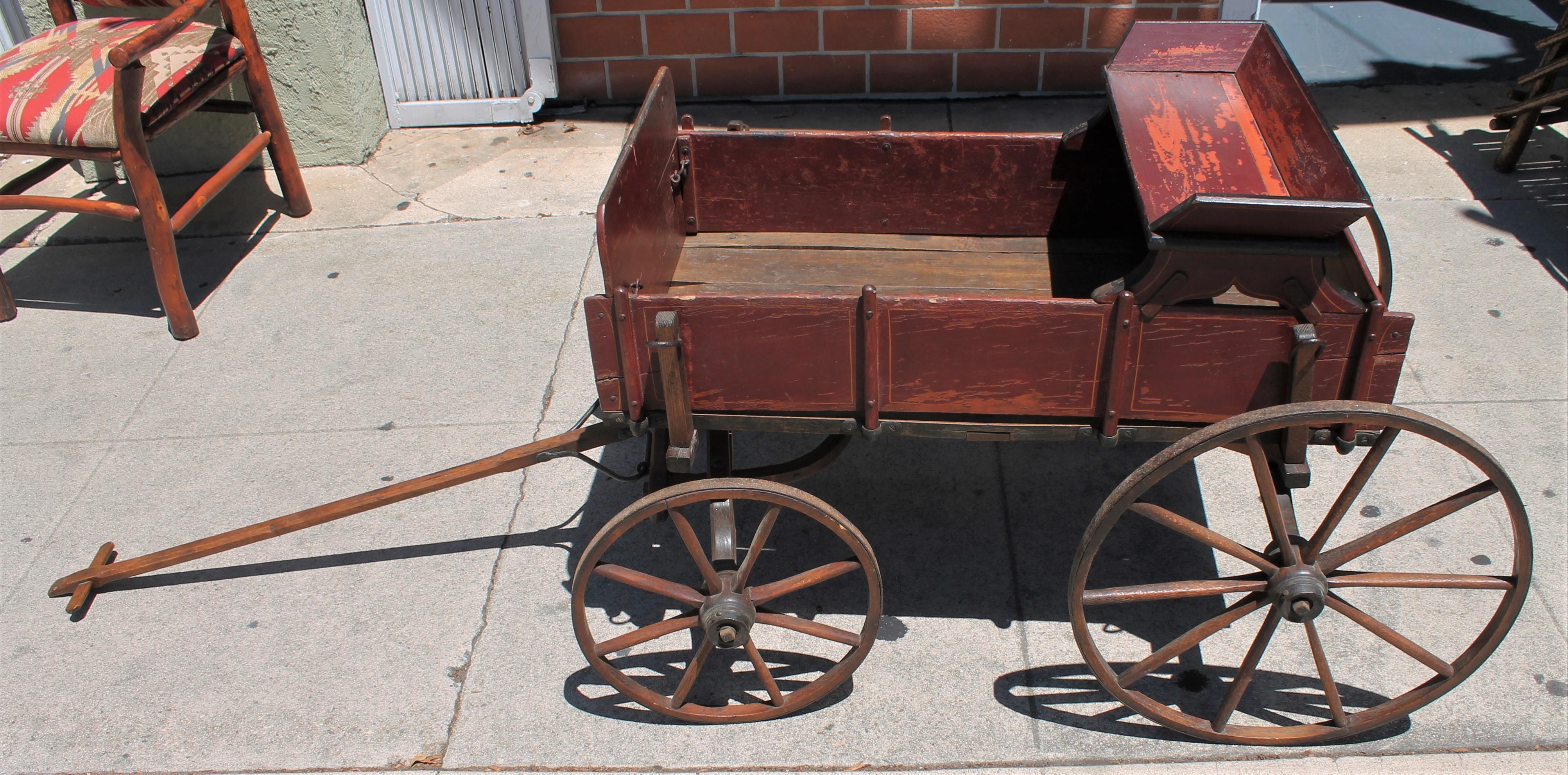 This fine example of Folk Art original painted buggy was probably pulled by a goat or donkey and has a upper child's seat on top. Fantastic pin stripe decorative painting. The buggy is all original and original wheels.