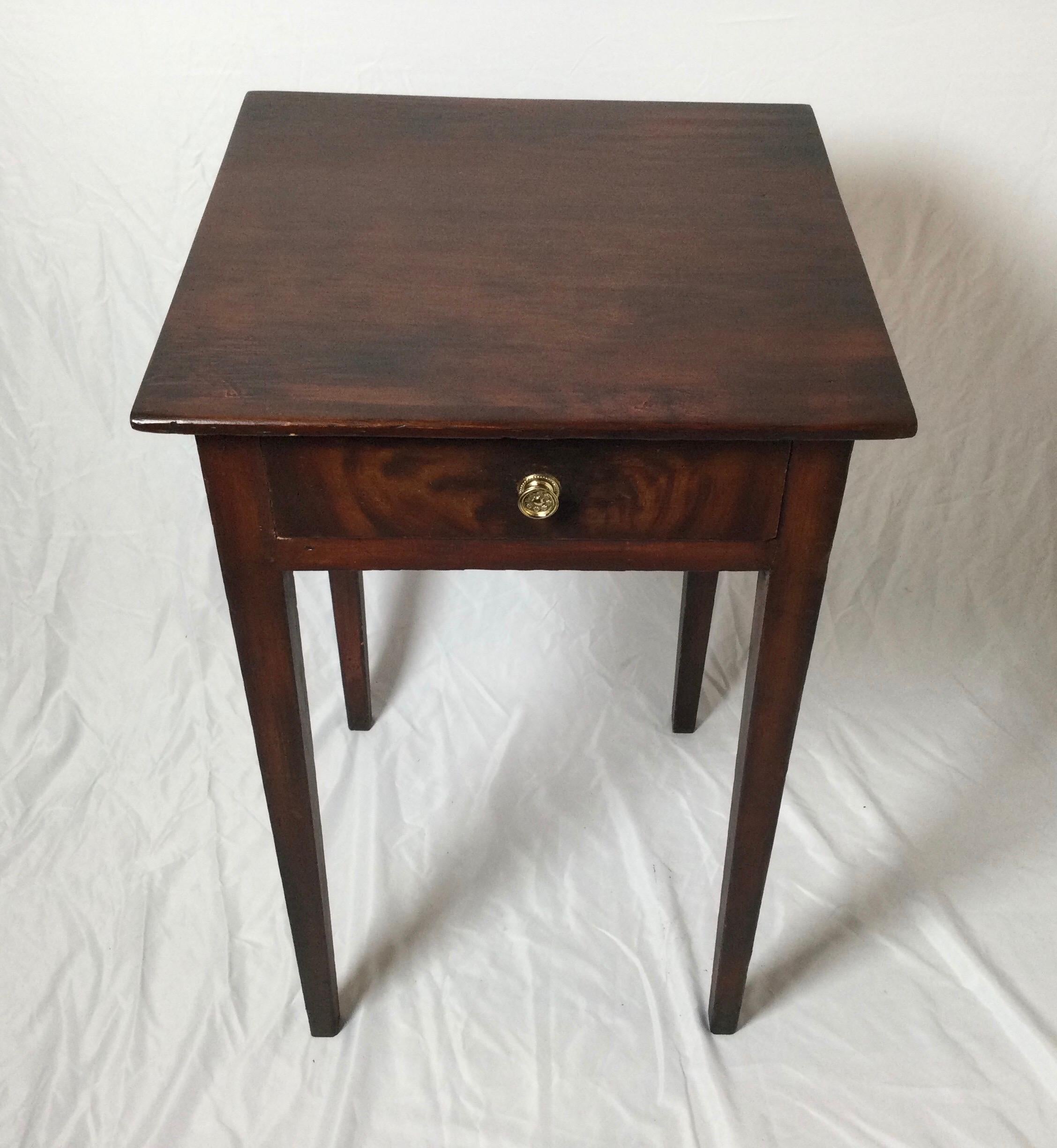 A paint decorated one drawer table. A paint finish resembling mahogany over pine, American Circa 1830. 29 high, 18 wide, 17.75 deep.