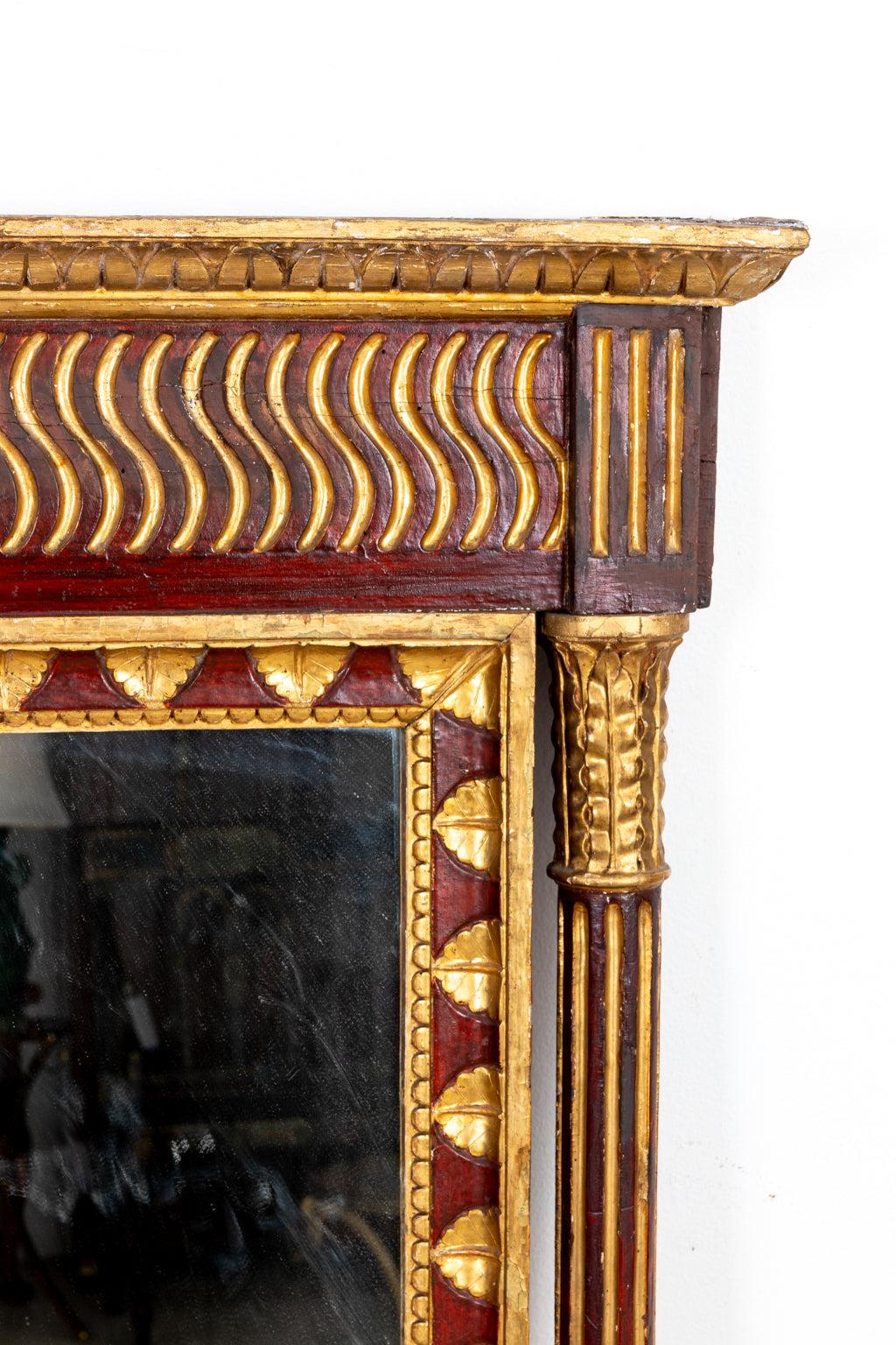 Early 19th century painted and gilt wood mirror in the Empire style with a molded rectangular shaped cornice accented by a central rosette medallion. The mirror is further detailed with round, fluted columns framing the sides of the mirror and