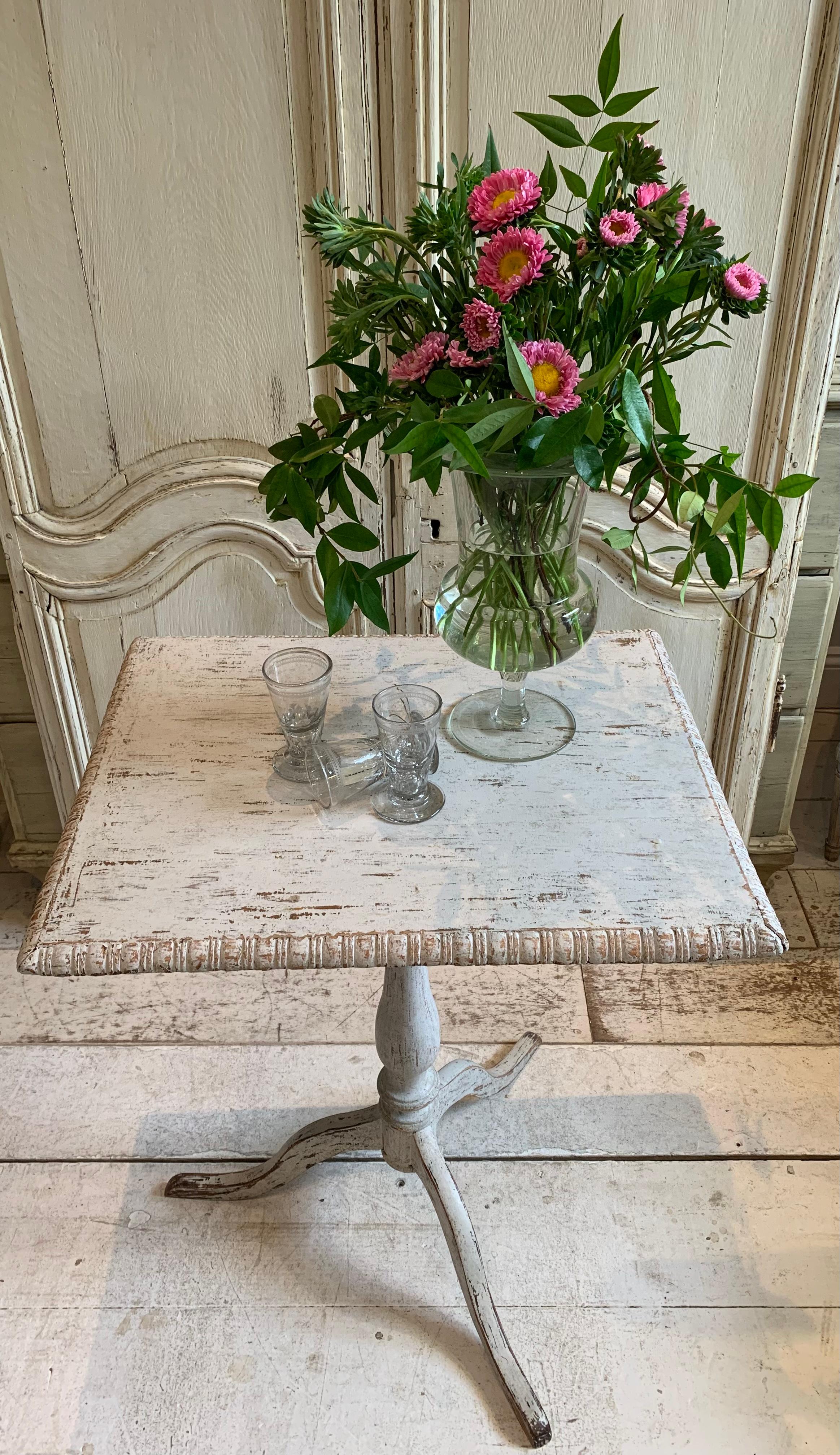 An understated early C19th painted tilt top table.
The rectangular top has carved egg and dart type border detail and tilts with simple removal of peg below.
Hand scraped and refreshed in a soft pale blue grey colour, this table would add a Country