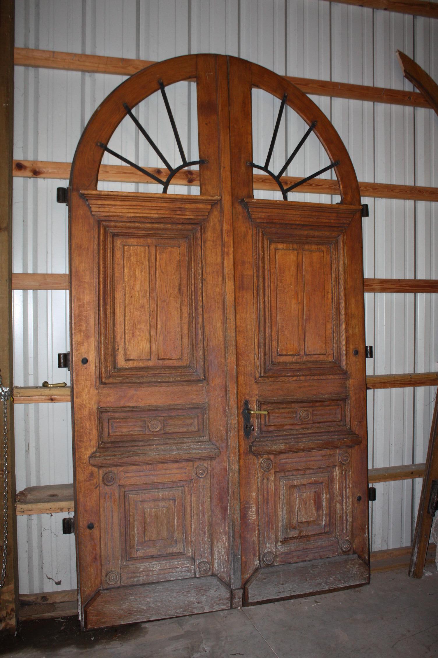 This is one of the best looking set of French exterior doors I have seen. They have a very nice arched top shape. It is a complete original set with all hinges, locks, two keys, jam. The glass in the upper arches are missing which would need to be