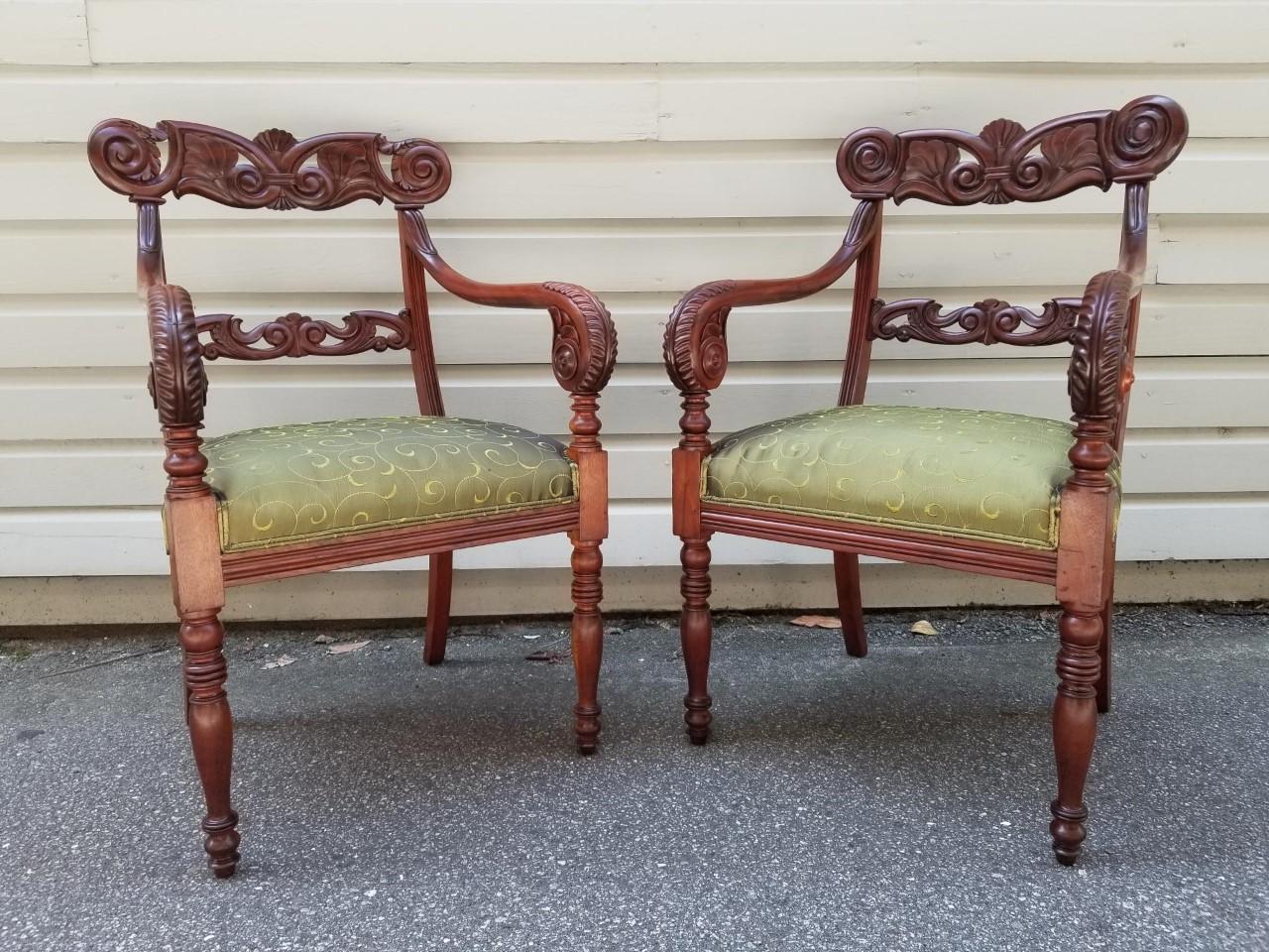 This wonderful pair of early 19th century Caribbean, West Indies Regency chairs are from the Lesser Antilles. They are made of Mahogany, carved with a double Lotus Crest and an elaborately carved back splat. The back splat is connected to the