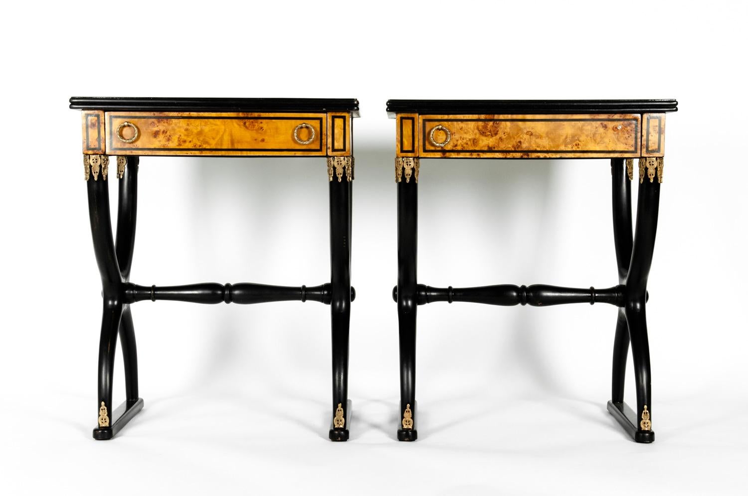 Pair of partially ebonized side or end tables in the style of Charles X, with grecque key top design details. Each table is in excellent condition. Each Table measure 28.5 inches high x 24 inches width x 16 inches deep. 
 