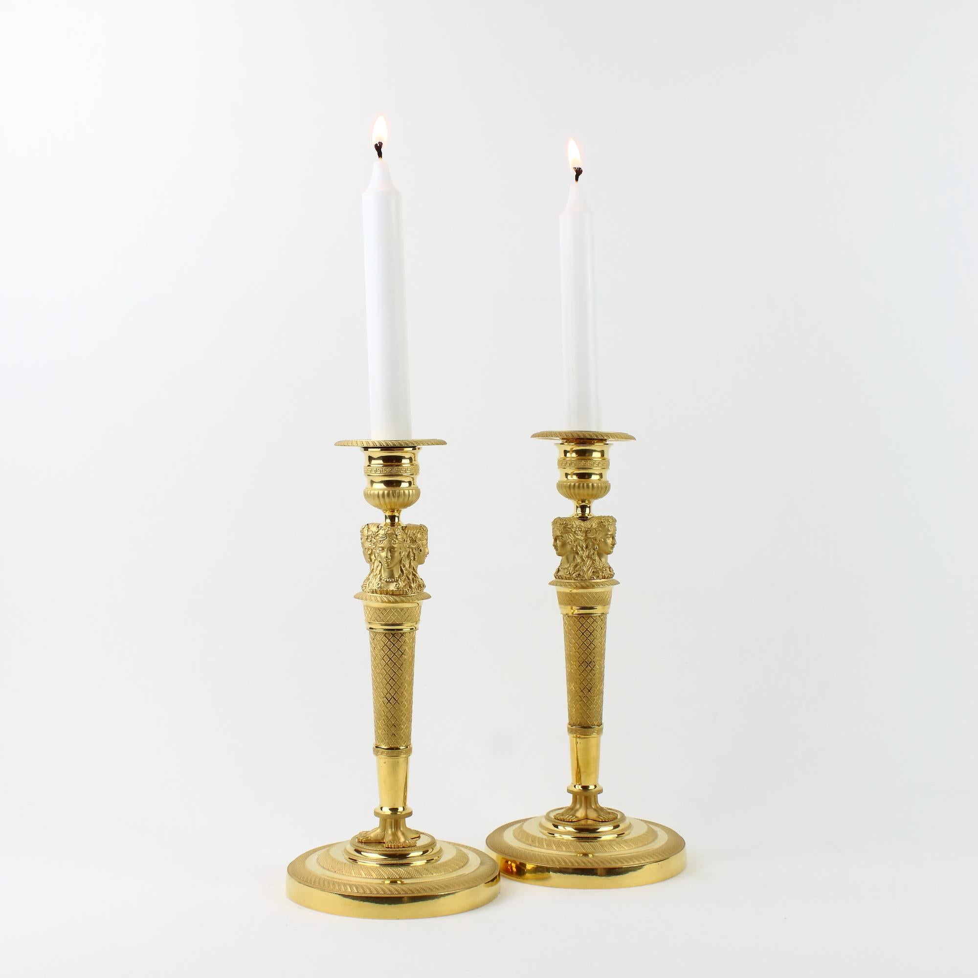 Pair of Early 19th Century French Empire Ormolu Gilt Bronze Female Busts Candlesticks, circa 1820

A beautiful pair of Empire gilt-bronze ormolu candlesticks decorated with three female busts or caryatids, their hair being decorated with flower