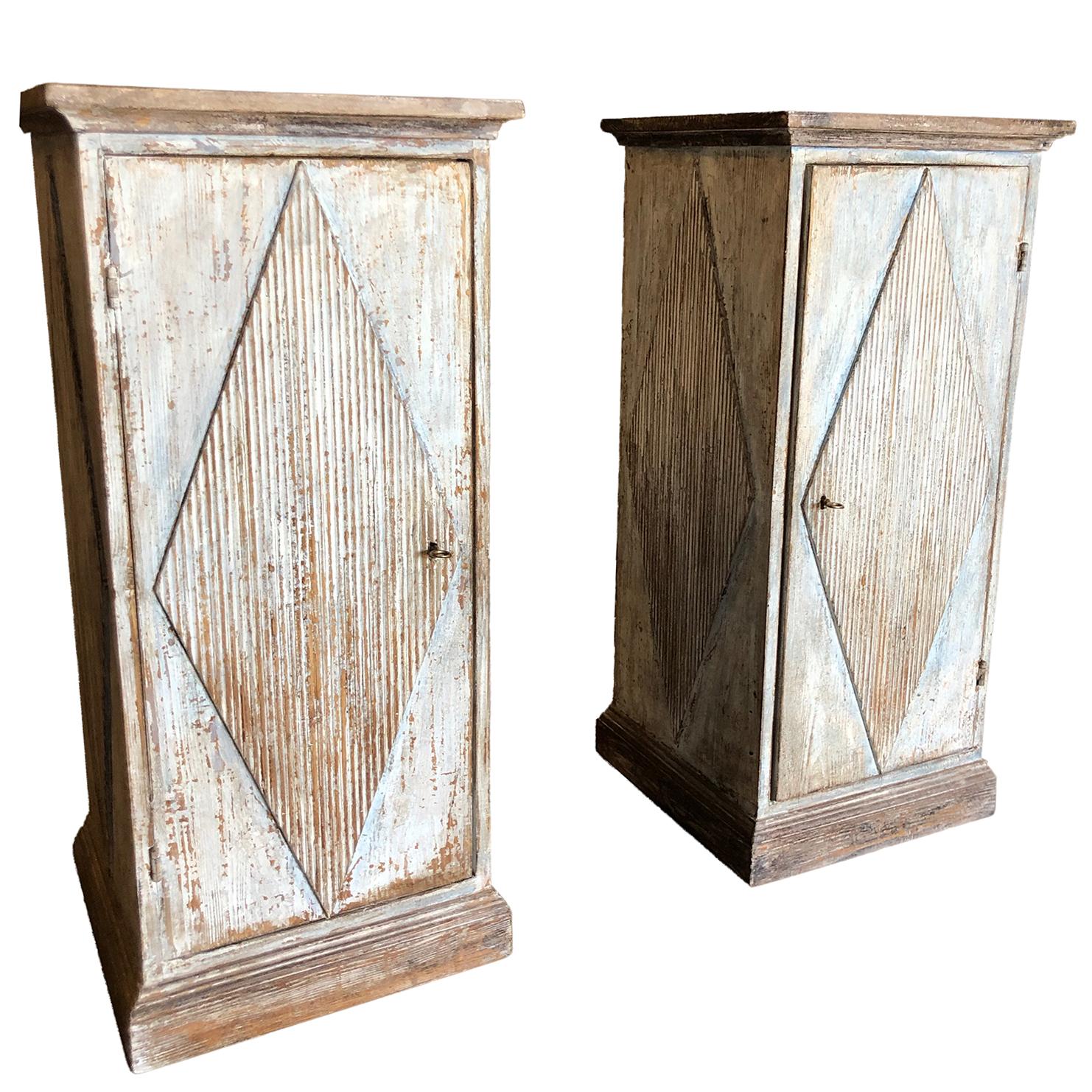 A light-white, antique pair of Swedish Gustavian square pedestals made of hand carved oakwood with raised rhombic decoration on front and sides with chalk painted finish on wood. The front panel opens, key included, in good condition. Wear