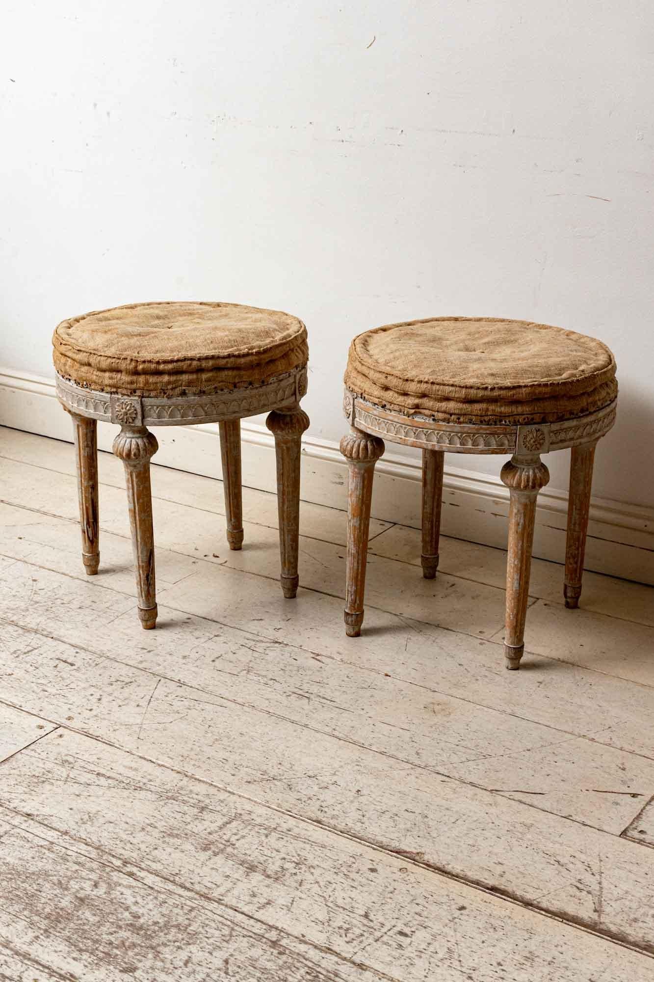 An unusual and exquisite pair of Swedish early 19th century Gustavian period round stools. Set on four grooved tapered legs, the stools feature beautiful detailing to the top of the legs, where they meet the seat, and around the seat base itself.