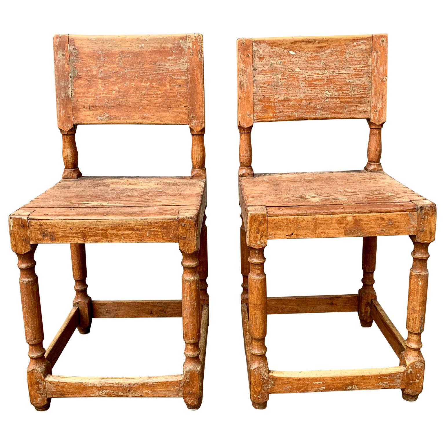 A pair of early 19th century Folk Art chairs from Northern Sweden. The chairs retain the original old charming patina and paint. This characterizes the few antique pieces of Swedish furniture remaining with the untouched look.

