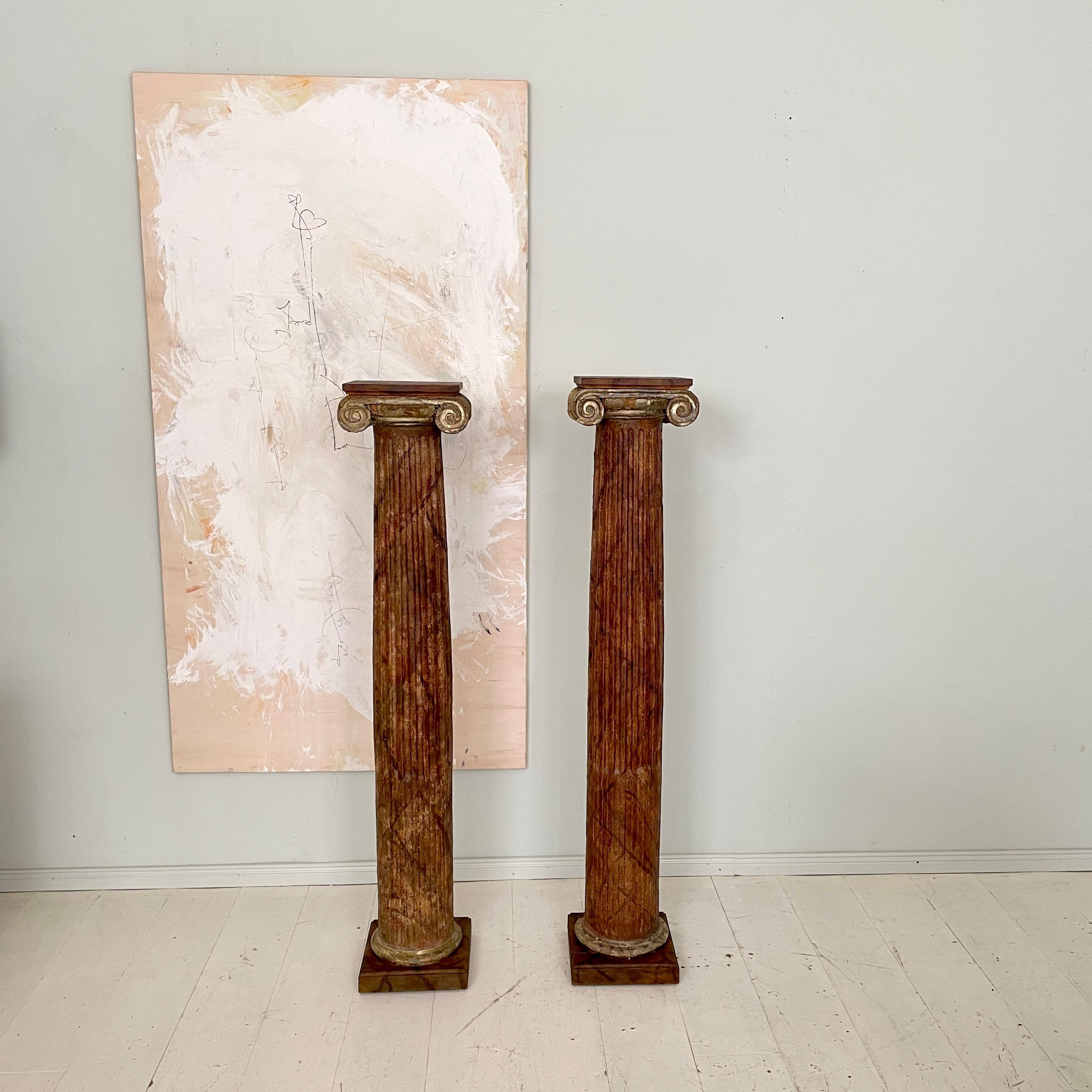 This beautiful Pair of Early 19th Century Wood Columns Lacquered in Faux Marble has been made around 1800.
They are in a beautiful original condition. Apart of the two top lid parts, which have been re-lacquered or replaced at some part.
Great