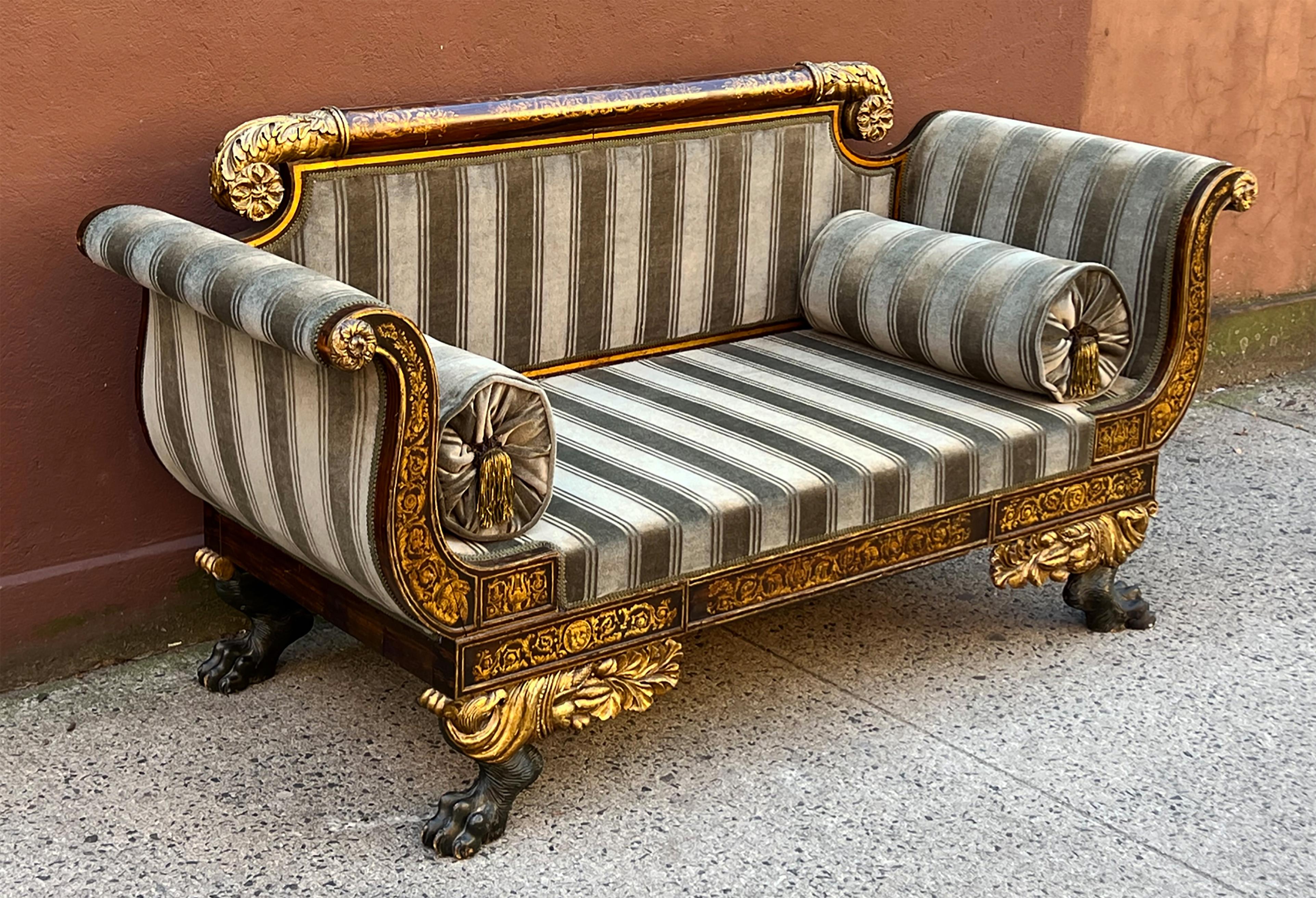 A spectacular American Empire sofa with exquisite detailing and design. One of the masterpieces of Federal New York furniture, this circa 1820 parcel gilt sofa with faux bois Rosewood graining almost certainly originates from the same shop as a