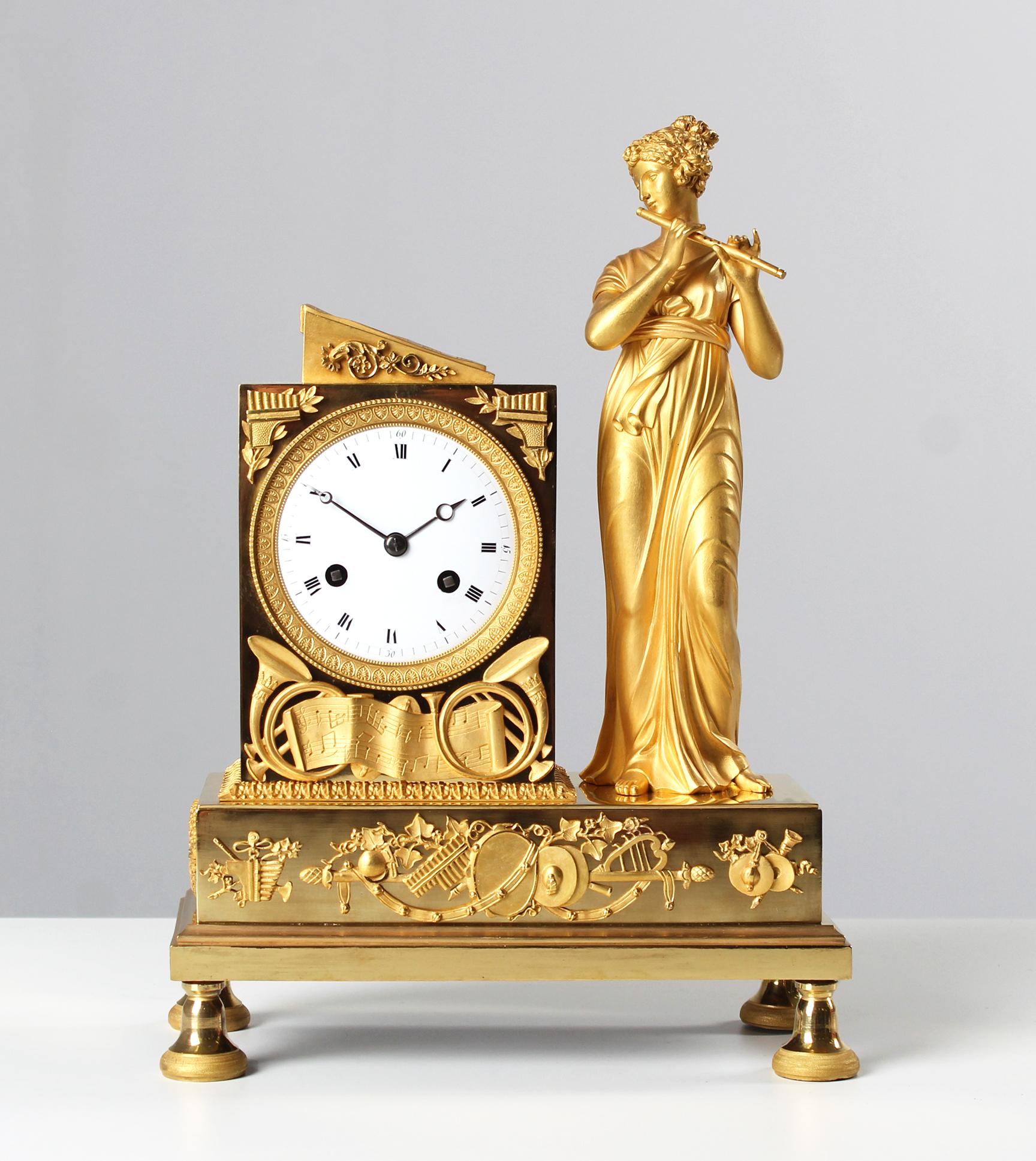 Antique Empire Pendule, Fireplace Clock France circa 1815

France
Bronze gilt
Empire around 1815

Dimensions: H x W x D: 35 x 25 x 12 cm

Description:
Pedestal standing on bell feet with applied musical instruments held by festoons and