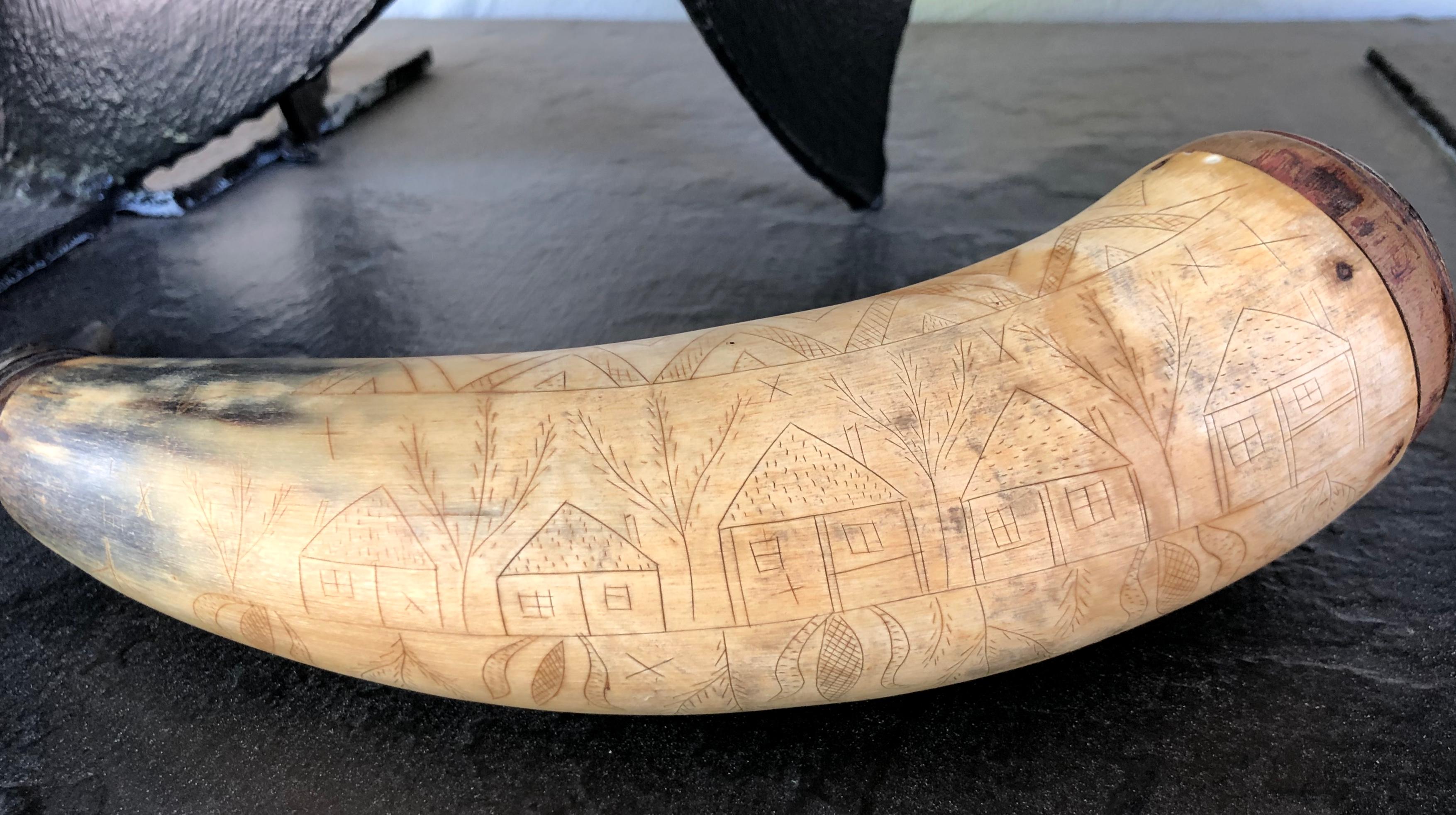 Featuring 5 houses, 5 diamonds, 5 sets of triangles, and 5 trees. There are also sets pinwheels and flowers. Similar style carved powder horns are known to have come from eastern Pennsylvania. There is a very folky man featured as well. Great