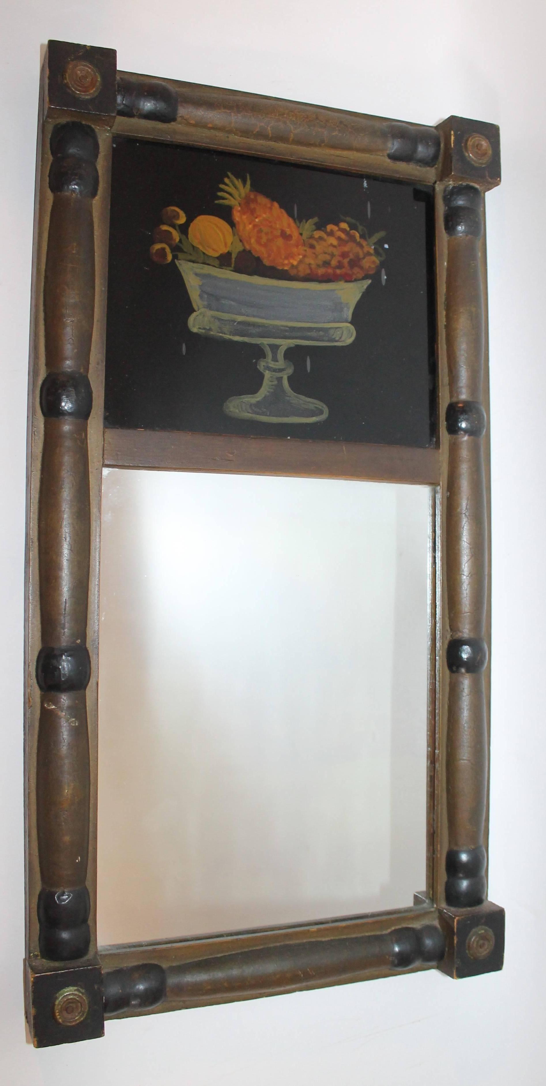 This early 19h century mirror with reverse painting of fruit bowl within the top enclosure. Original period wavy mirror and painted frame.