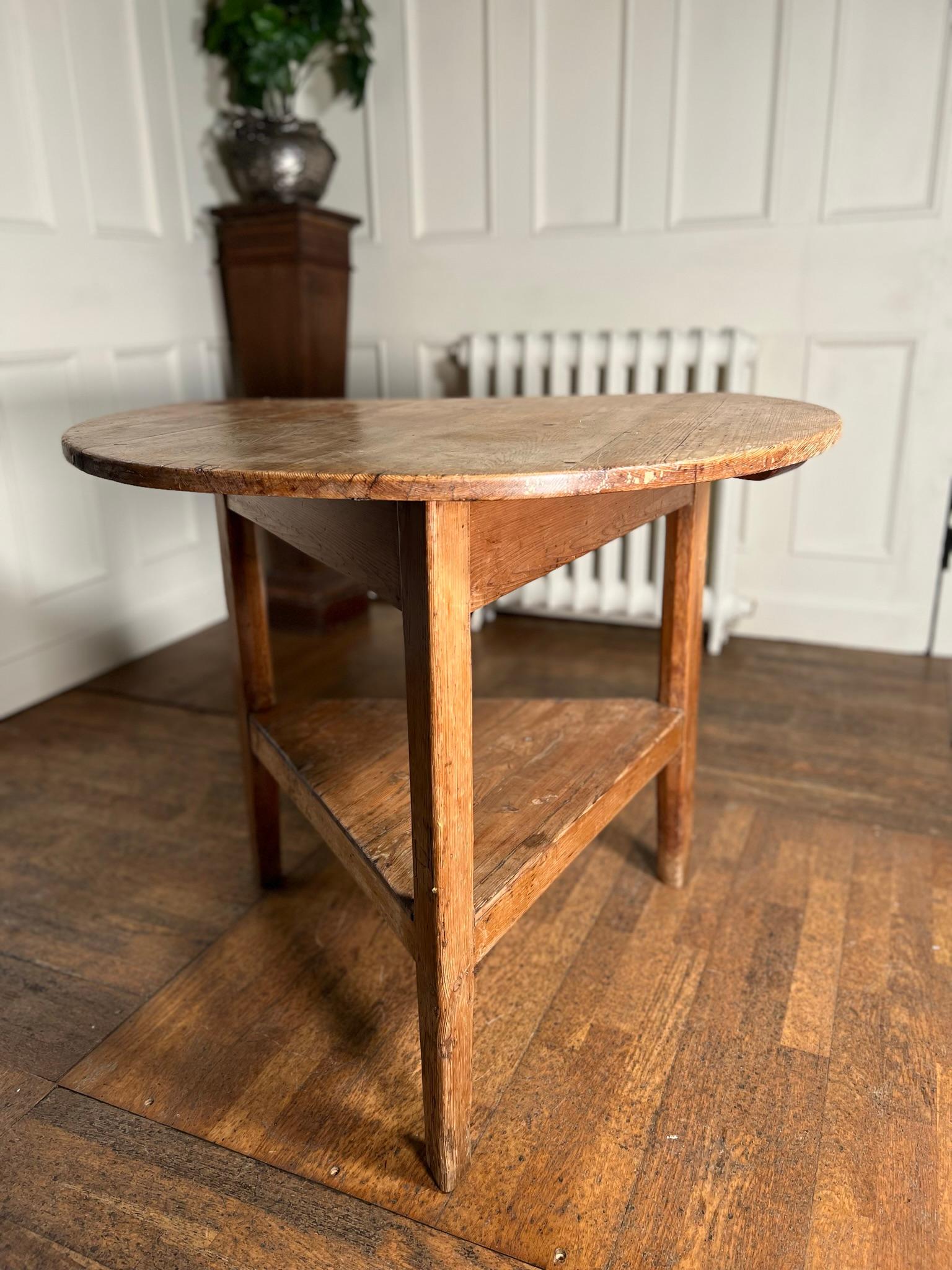 Early 19th century pine cricket table.

Historic ‘modification’ allows this to be used against a wall as a console table.

Washed out, waxed pine top with historic signs of worm, knocks and bumps.

Exactly how it should be.

English,