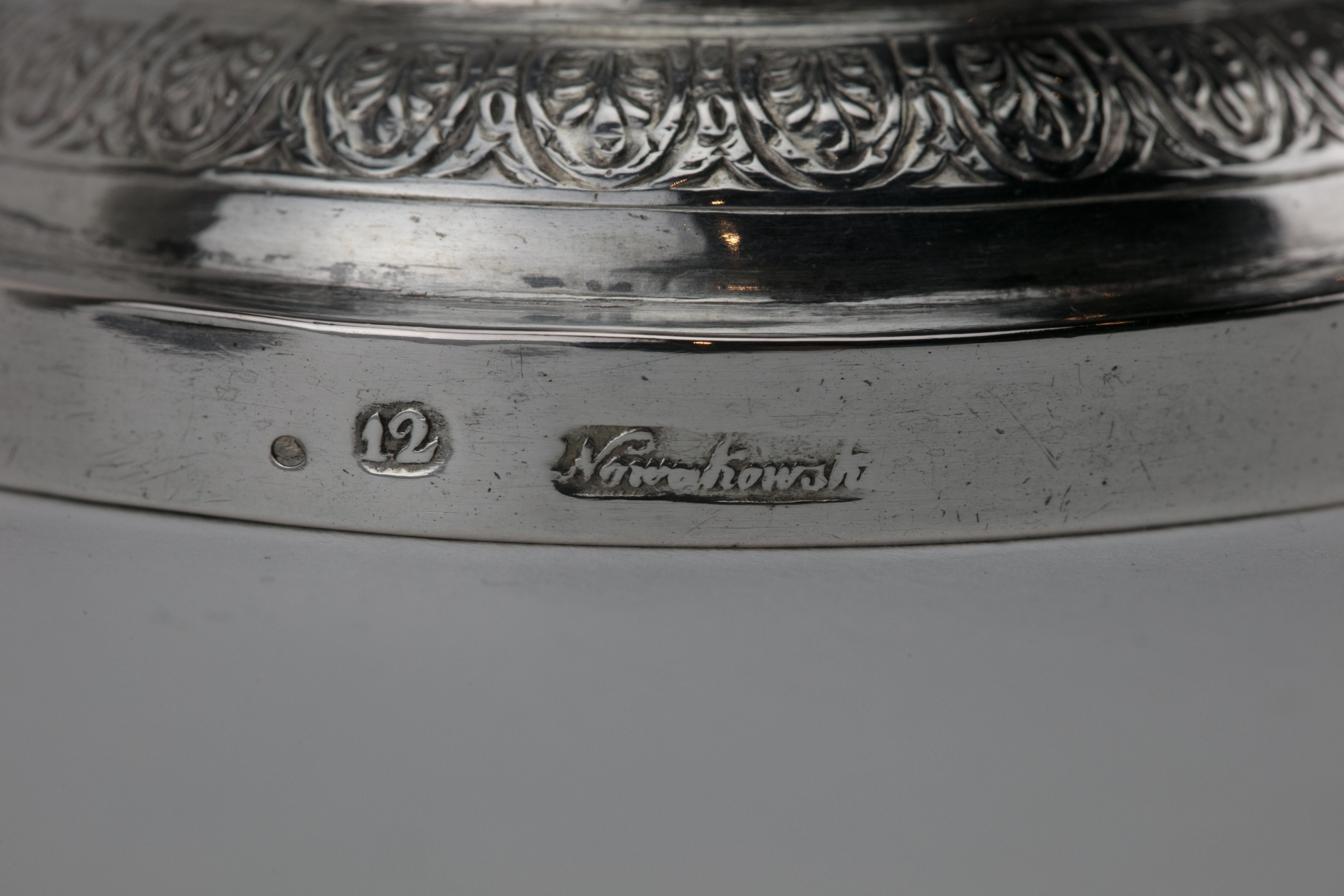 Handmade silver Kiddush goblet, Poland, circa 1820.
Large upper portion engraved with curtain decoration, set on a knobbed stem with skirt decoration on a round stylized base. Clearly struck with the quality mark 12 and maker's mark.

Kiddush cup is