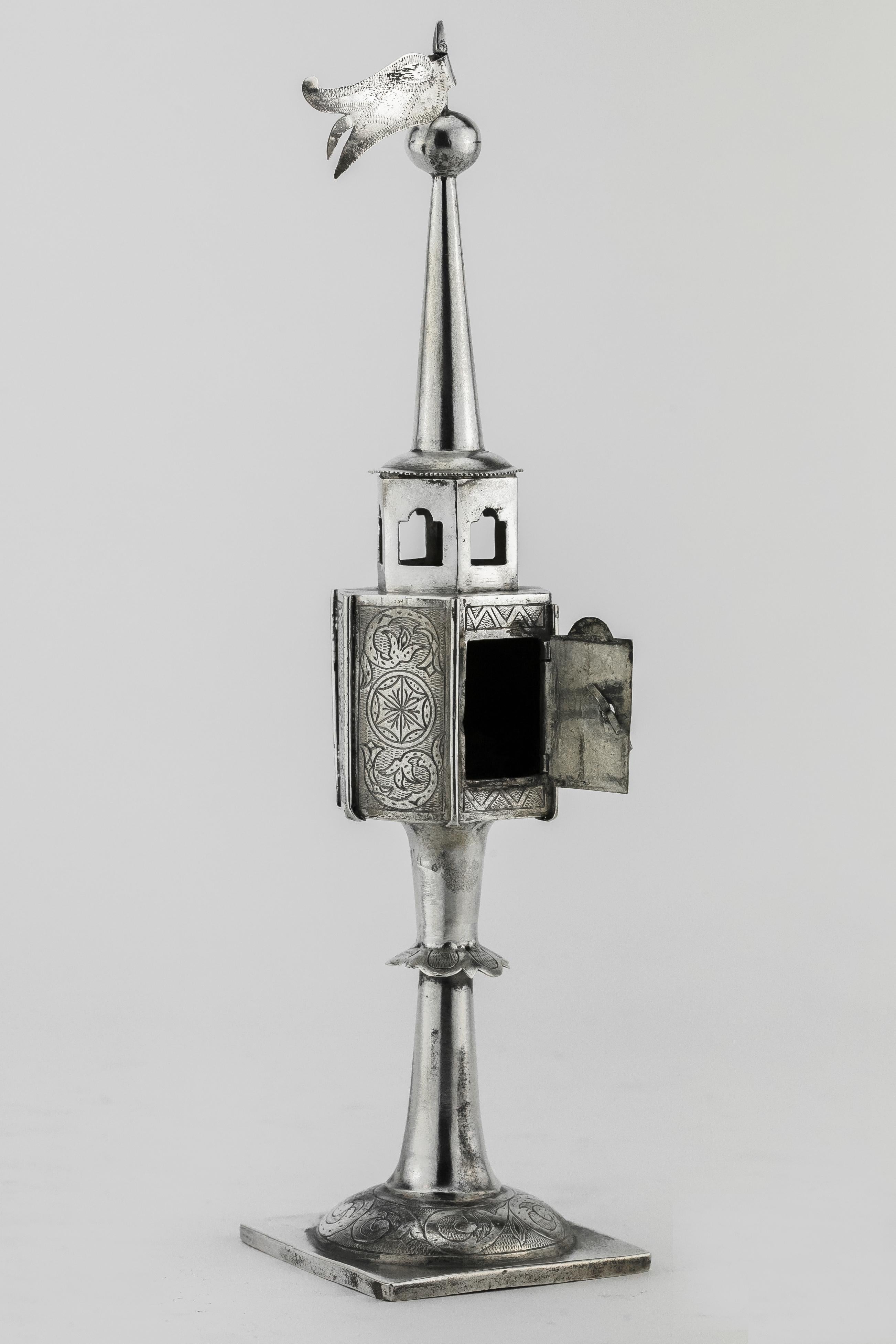 Handmade silver spice tower, Poland, circa 1800.
On base engraving with foliage design and skirt mounted around the stem. Upper portion hand engraved with floral motifs. The door is decorated with chess pattern. Topped with ball and flag.
Engraved