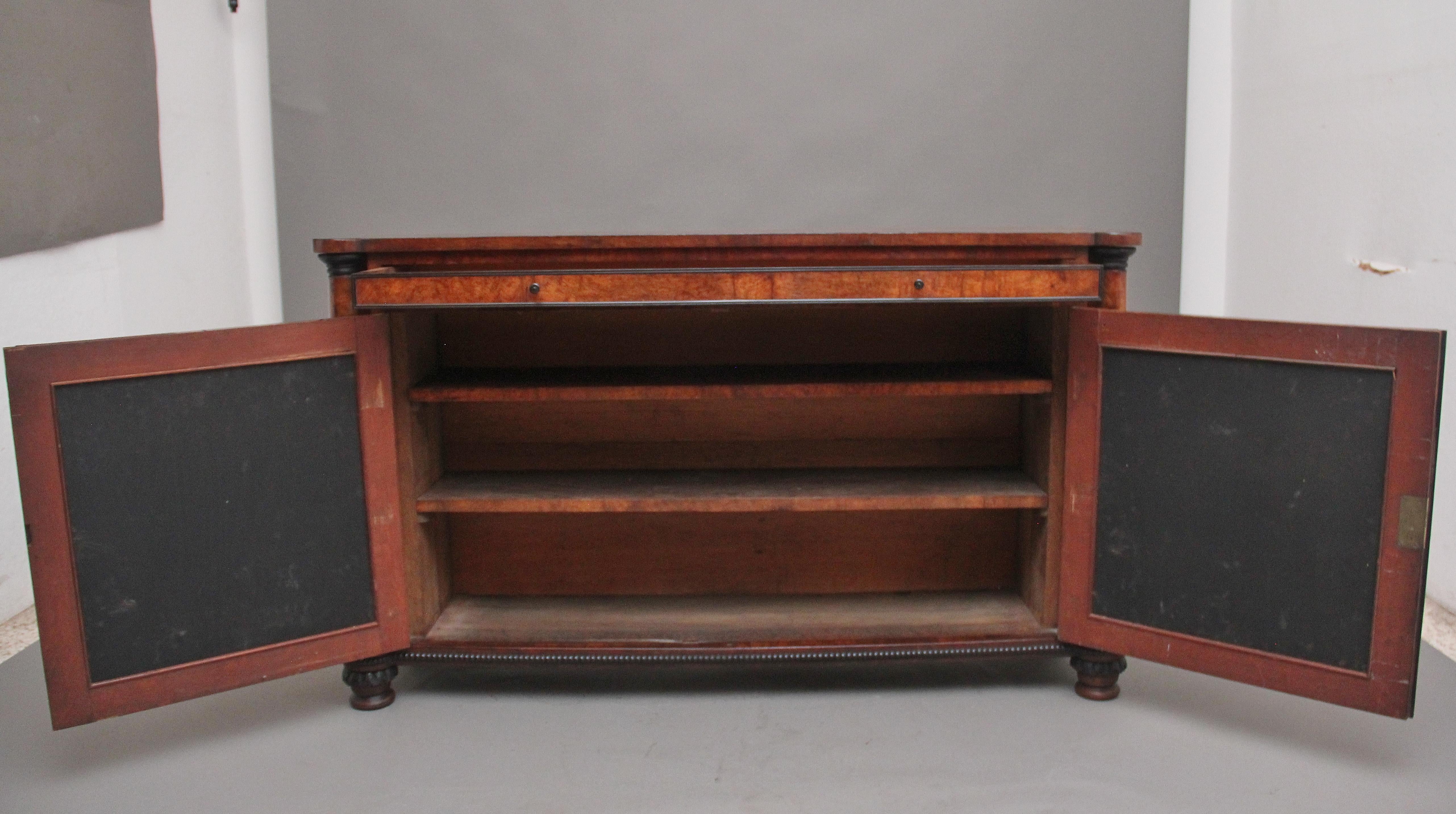 A superb quality early 19th Century pollard oak and ebony cabinet in the style of George Bullock, having a wonderfully figured rectangular top decorated with ebony inlay, a long frieze drawer below with the original ebonised turned handles and the