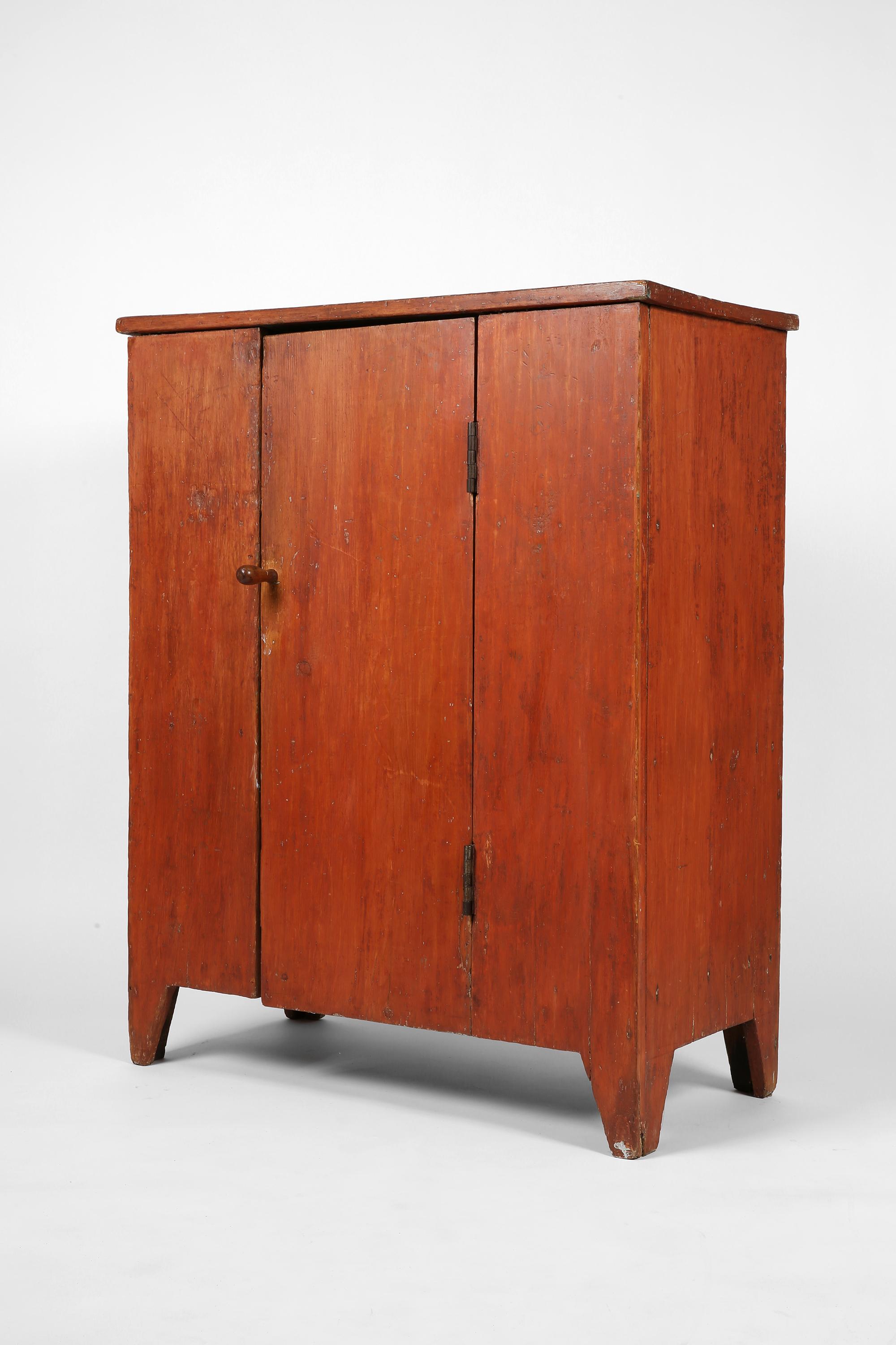 A charming, early 19th century Shaker cupboard, primitively constructed from pine timber. Retaining its original red wash to the exterior, the single door opens to reveal three shelves within, the interior with remnants of blue paintwork. Furniture
