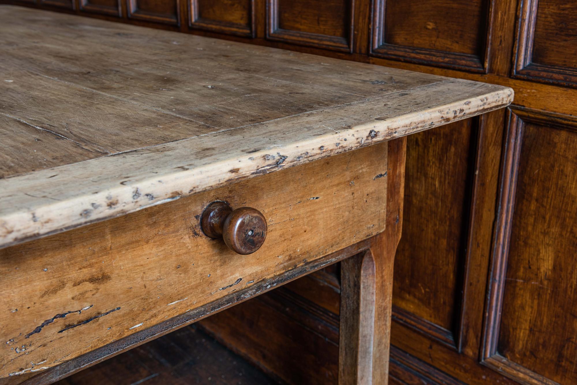Early 19th century provincial French Elm farmhouse table with two end drawers
sourced from the south of France, this rustic farmhouse table features two full length drawers - one either side. The oak cleated top a lighter contrasting color to the