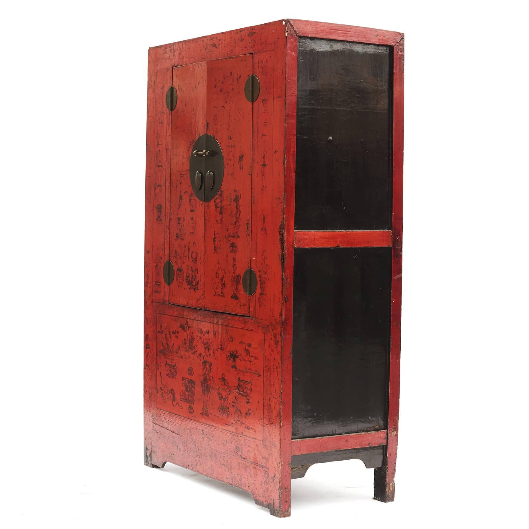 Chinese cabinet i red lacquer with remains of decorations, which gives the cabinet a beautiful patina. Black lacquer on the sides of the cabinet.
Features double doors, beautifully accented with a circular face plate. Behind the doors are two