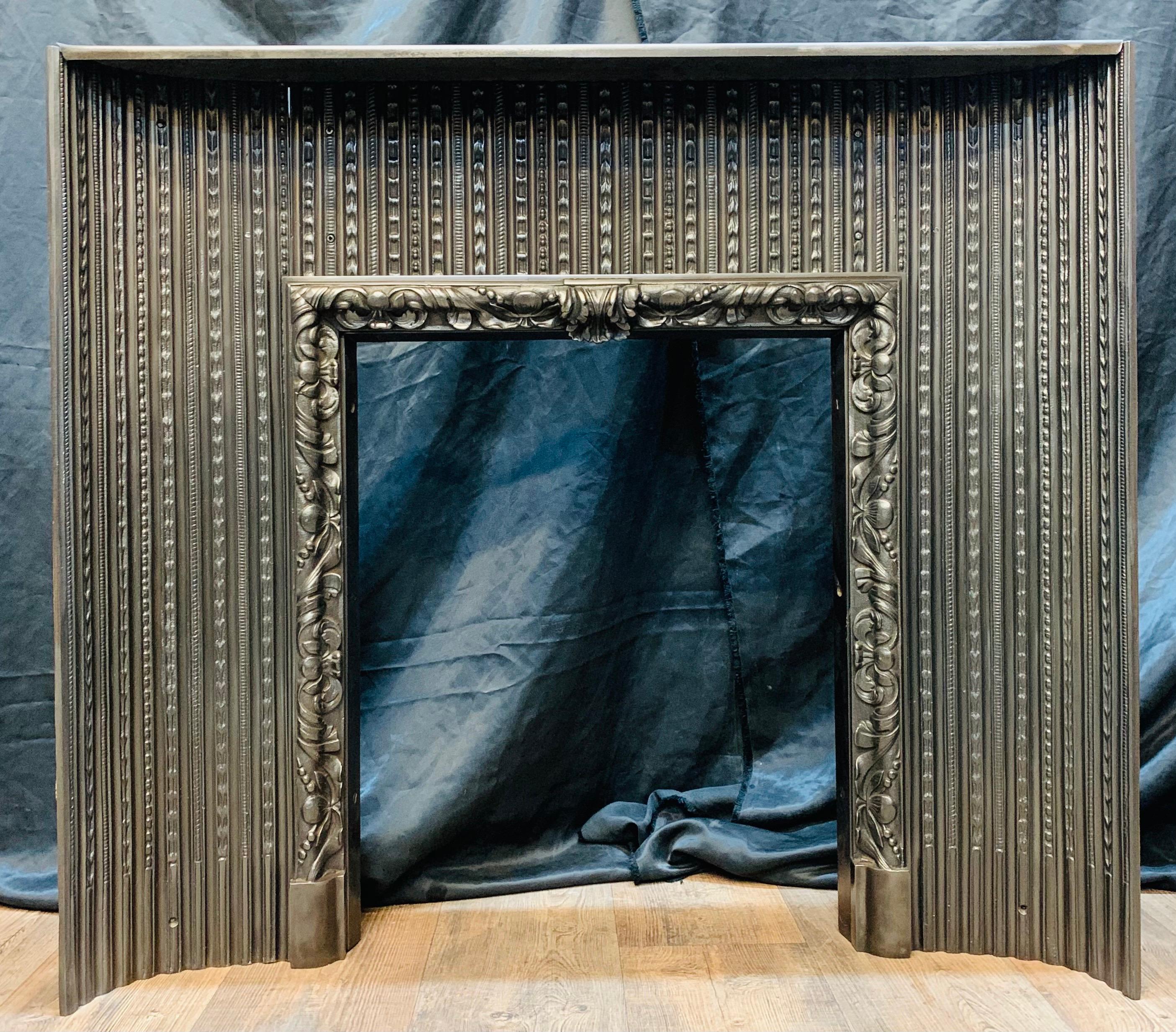 An early 19th century Regency cast iron fireplace insert of excellent quality. Convex interior ribbed panels connect to a central acanthus leaf internal fire frame resting on foot blocks. Graphite polished to bring out the quality of the castings.