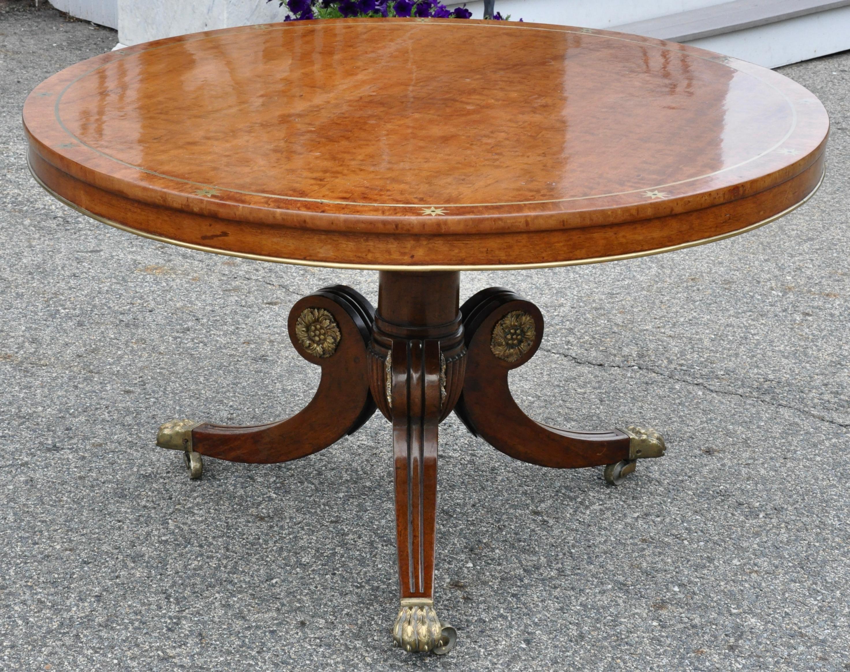 Round English Regency period dining table. Mahogany, cedrela and other colonial wood. Original brass star and ebony inlays. Tilt top mechanism. French polish. Center table.