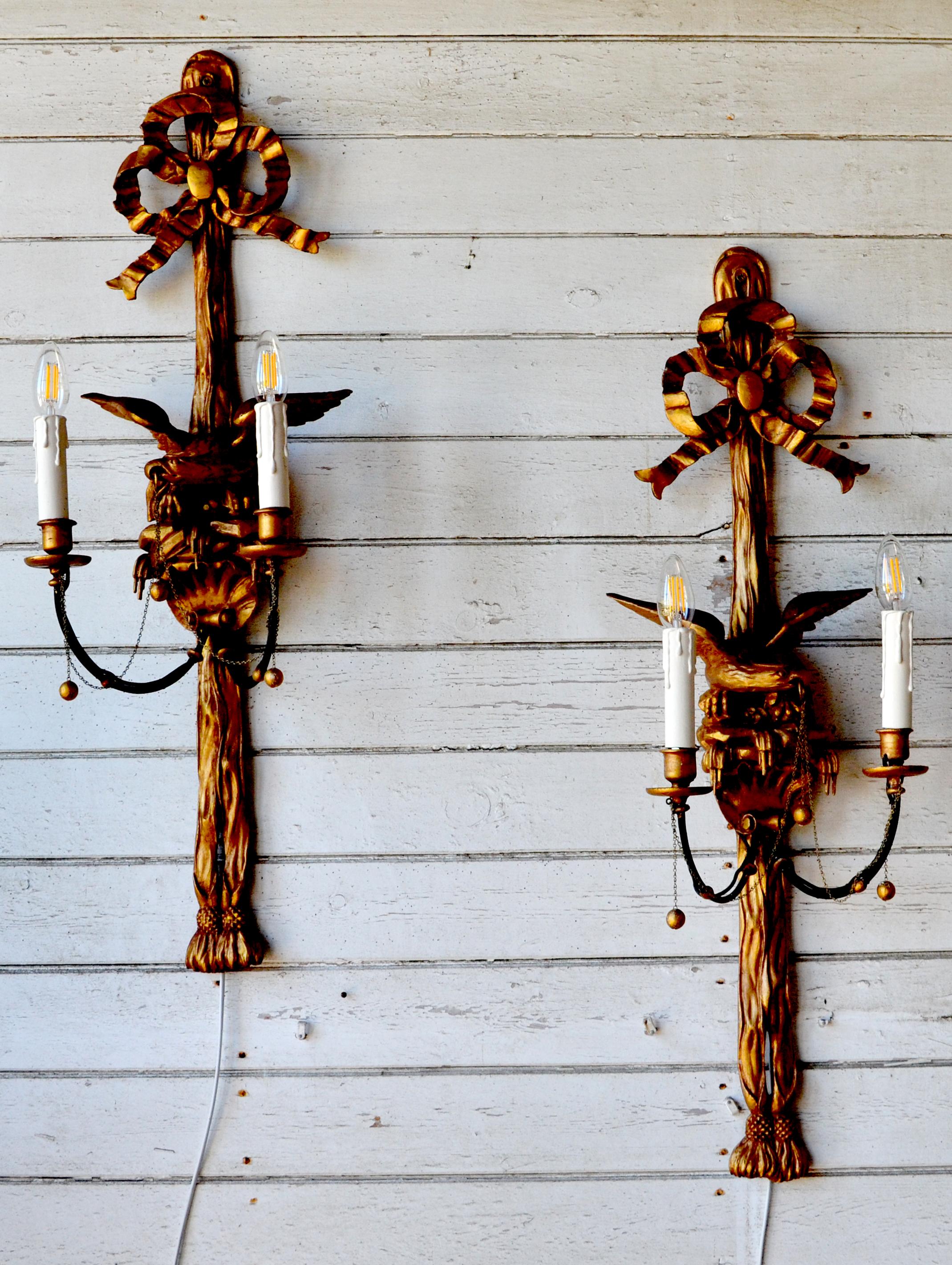 A very fine pair of  Early 19th Century Regency hand carved giltwood Eagle Wall Sconces. Original designed to hold candles, they have sympathetically modified for electricity. 

Exquisitely carved eagles sit atop a plinth with a scalloped shell