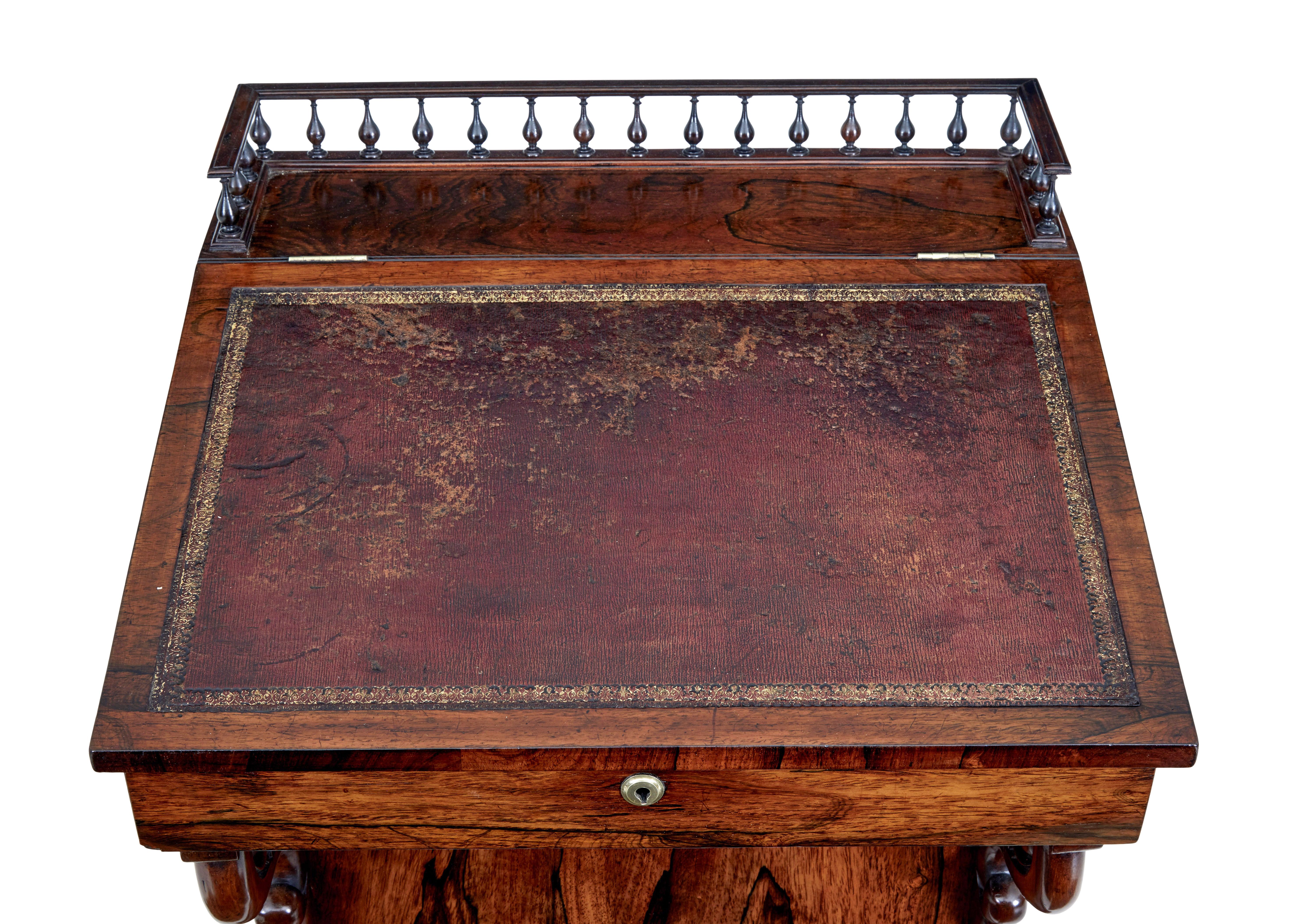 Fine quality regency davenport, circa 1820.

Spindle gallery to the top leading to the original leather writing surface. Top opens to reveal a richly colored interior with 2 drawers.
Writing slope lifts up and with the aid of 2 brass arms, maintains