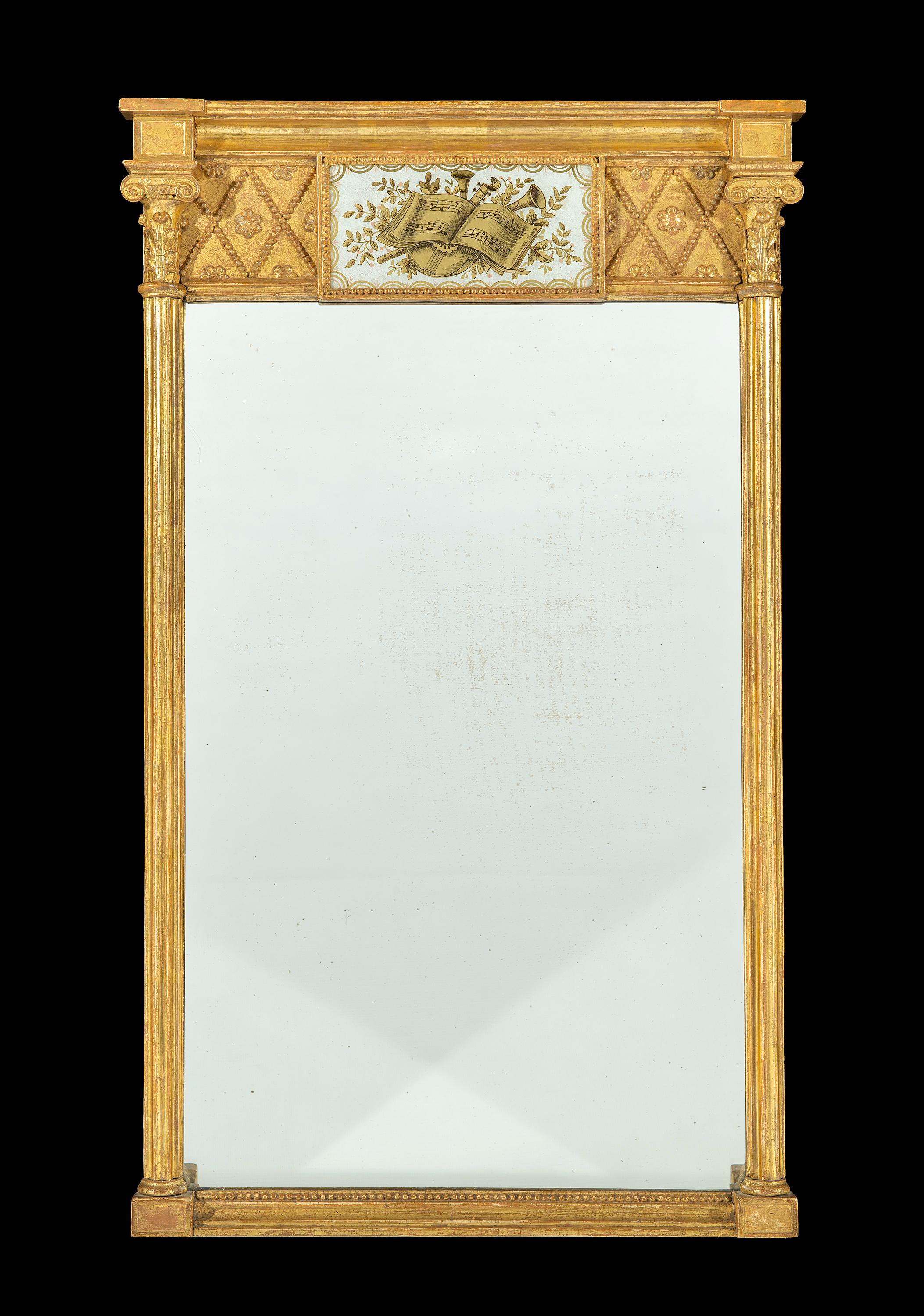 Early 19th century Regency period eglomisé carved giltwood pier mirror
The bevelled breakfront cornice sits above a musical themed eglomise centre panel and fine composite beaded mouldings and patera motifs which are of excellent quality. The