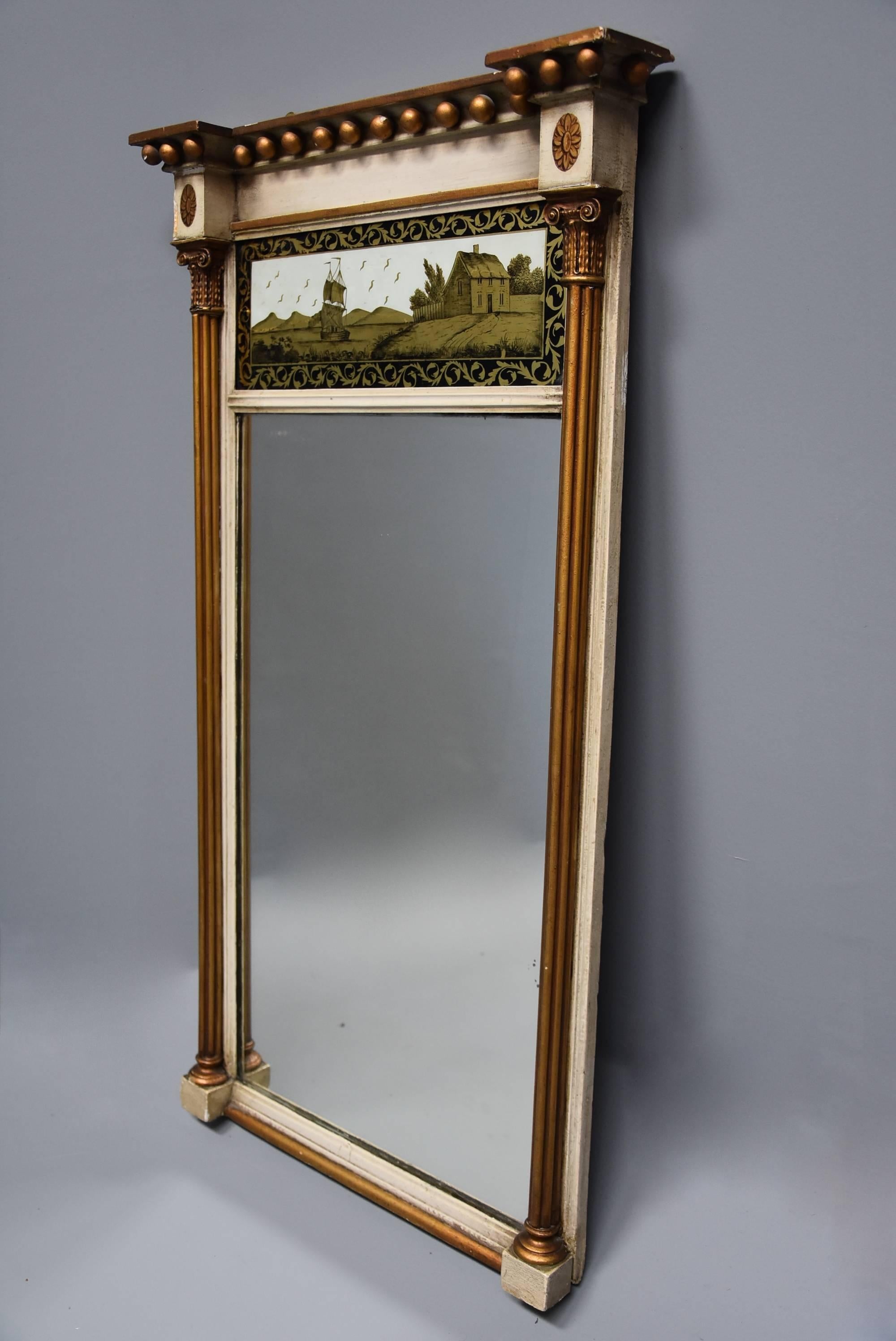 An early 19th century Regency églomisé, gilt and painted pier mirror.

This mirror consists of a ball decoration to the top with oval paterae to either side with a central églomisé painted panel below.

This églomisé panel (reverse painted)