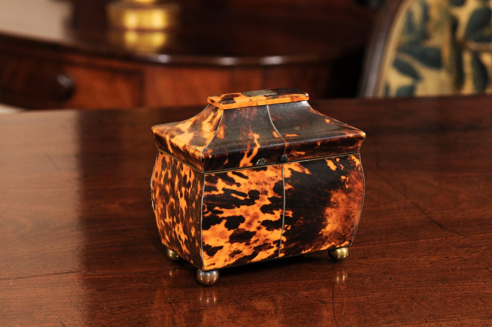 The Regency tortoiseshell tea caddy in the pagoda-form with fitted interior, brass ball feet and engraved T.B.B initials on lid.



 