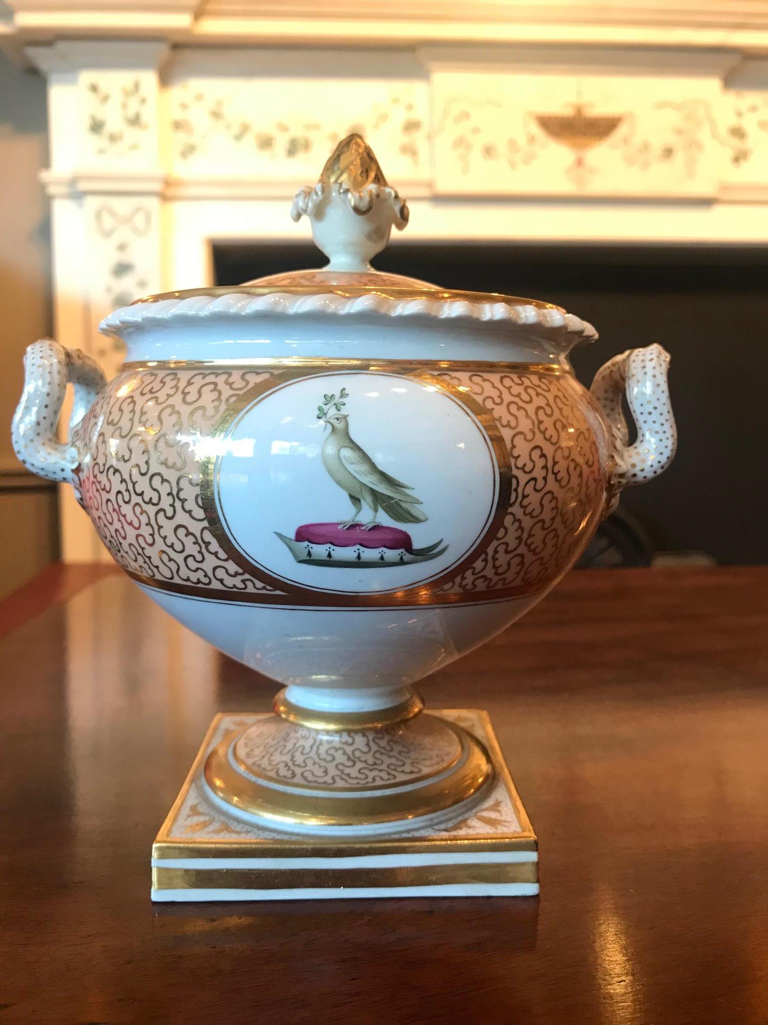 Early 19th century Regency Flight, Barr and Barr pair of porcelain lidded tureen of oval form, the lid with gilt banding against salmon pink ground with decorative gilt scroll motif with circular roundel of white ground surmounted with parcel gilt