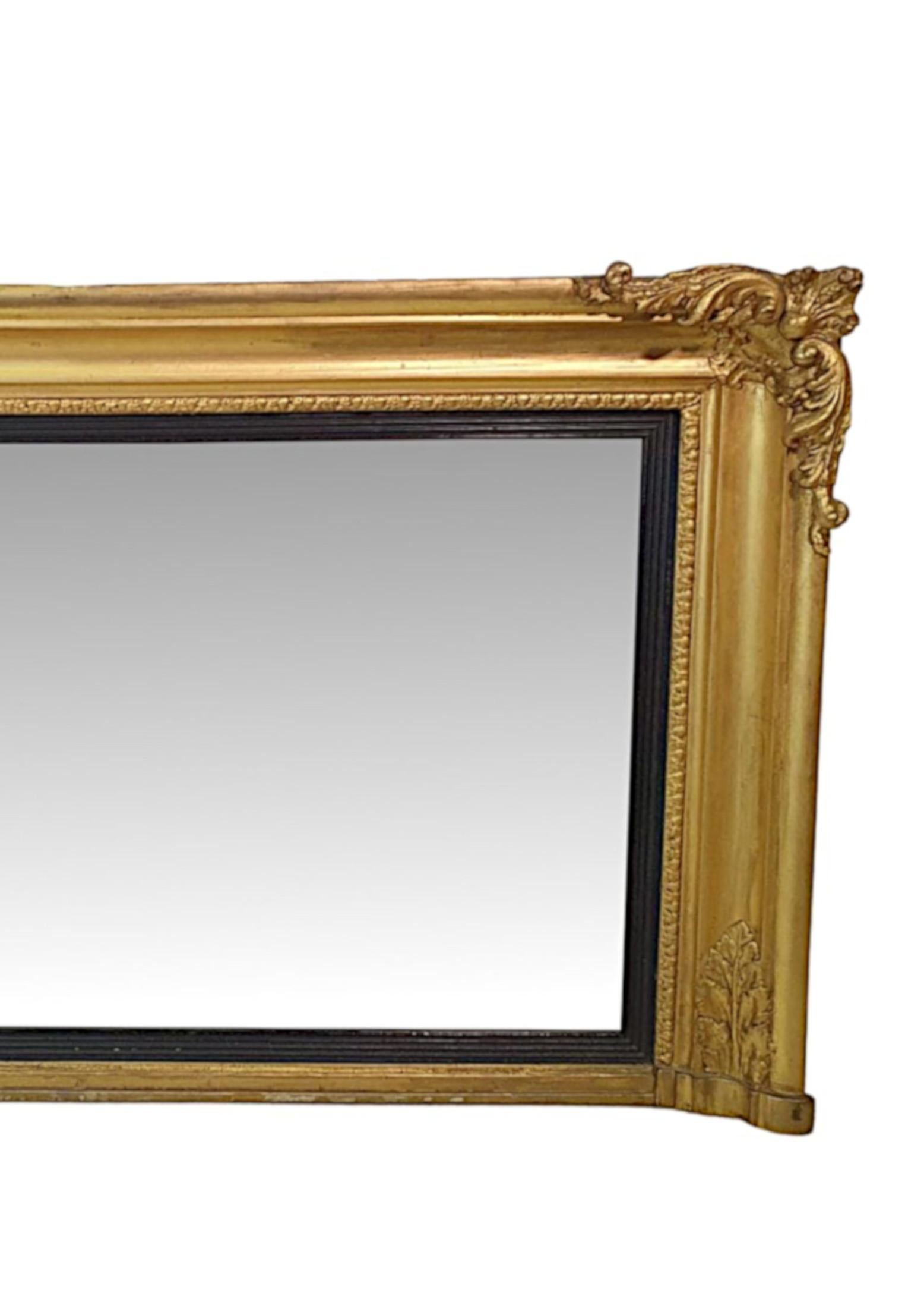 Early 19th century Regency giltwood mirror of rectangular form and neat proportions. The mirror plate set within reeded ebonised border within a moulded giltwood frame with acanthus and egg and dart motifs, surmounted with finely carved scrolling