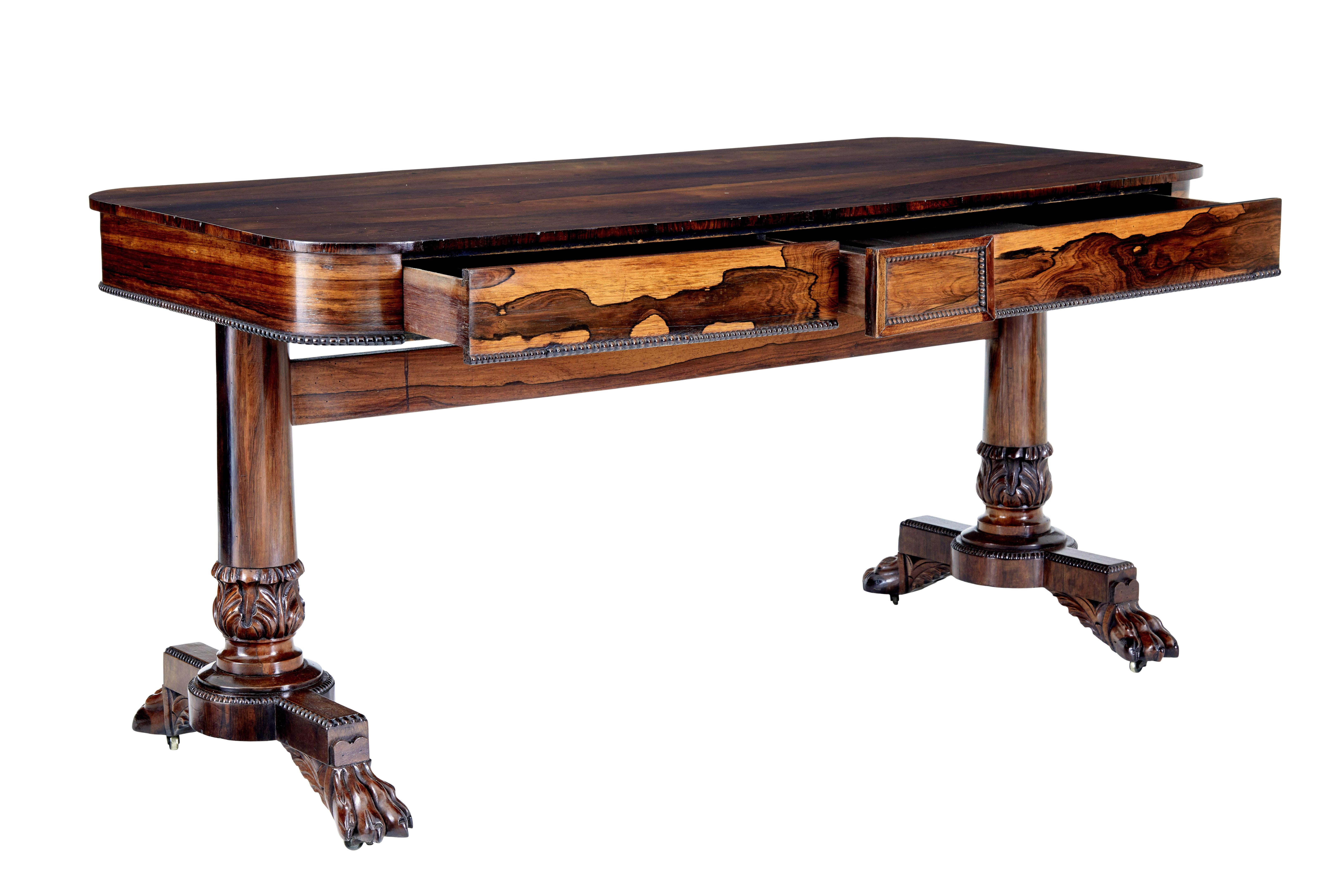 Early 19th century regency palisander library table circa 1820.

Elegant regency period library table veneered in striking palisander from the rosewood family.

Rectangular top with rounded edges, 2 drawers above the knee with beaded detailing. 
