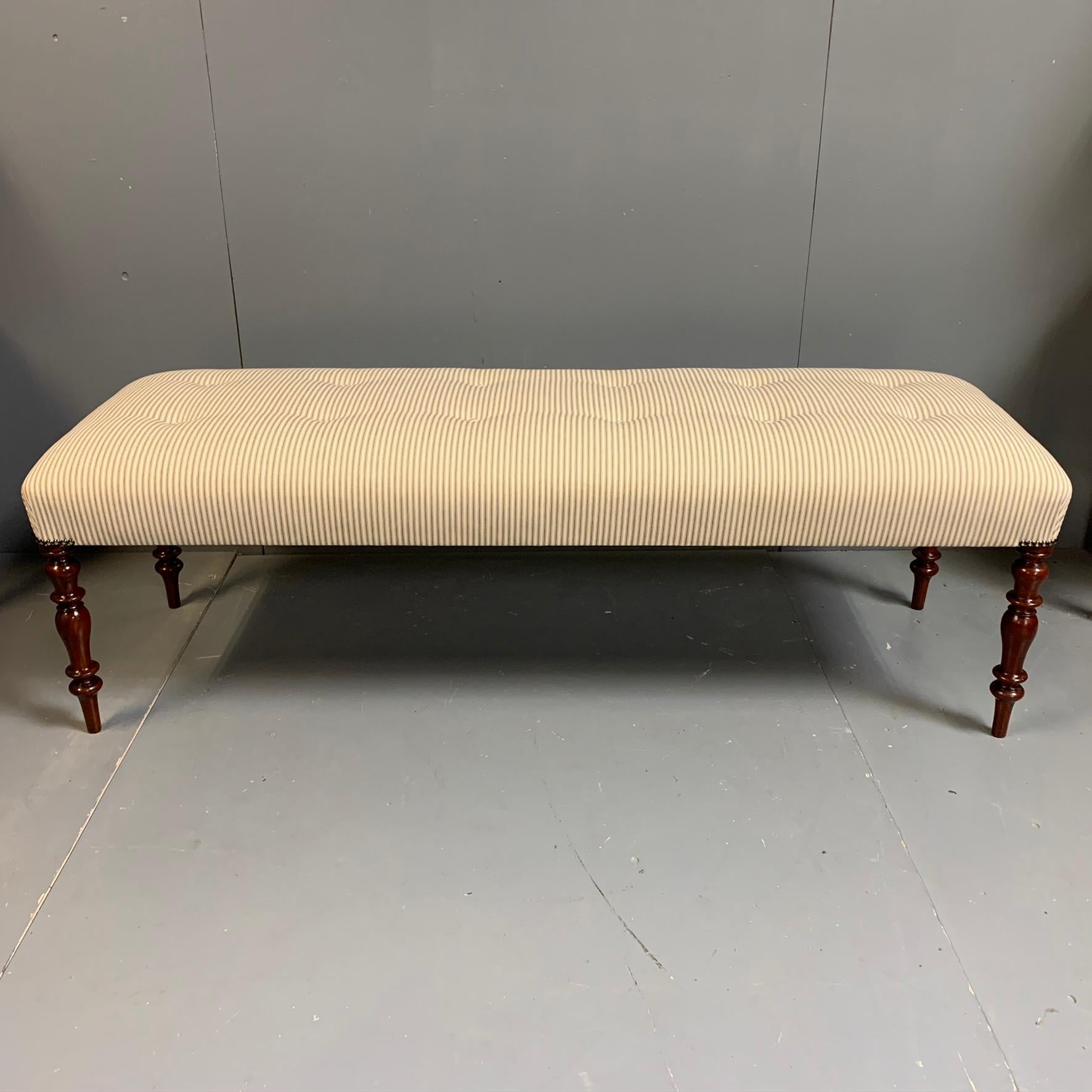 Fully restored and reconstructed Regency long stool in mahogany, fully re upholstered in traditional blue and off white ticking, finished with a buttoned top.
Great decor piece, but also gives useful occasional seating for three adults if