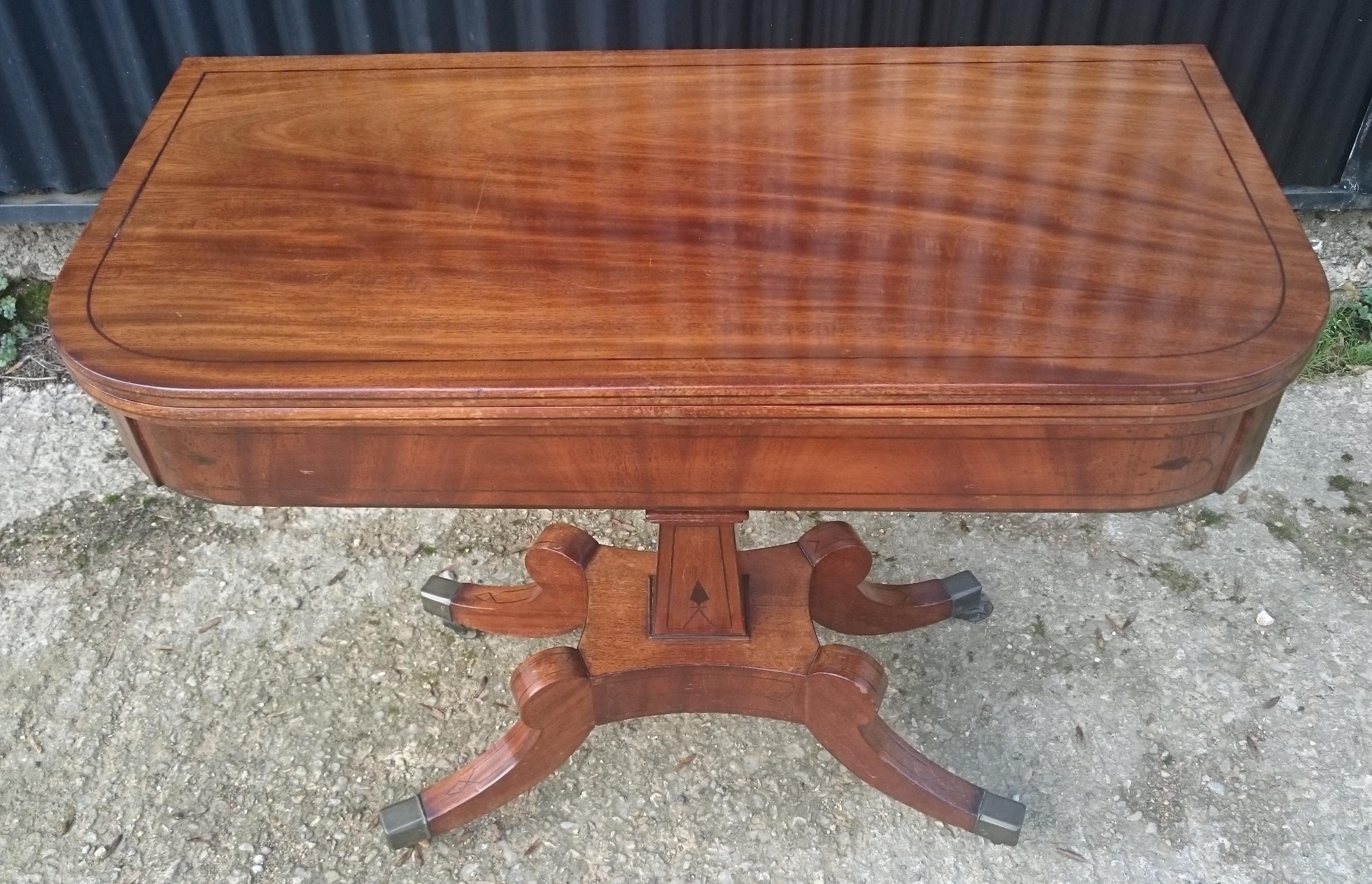 Early 19th century Regency mahogany antique card table standing on four splay base with a square column. There is ebony stringing to the edge, top, frieze and legs. The timber is a good quality piece of mahogany with lovely grain pattern which has