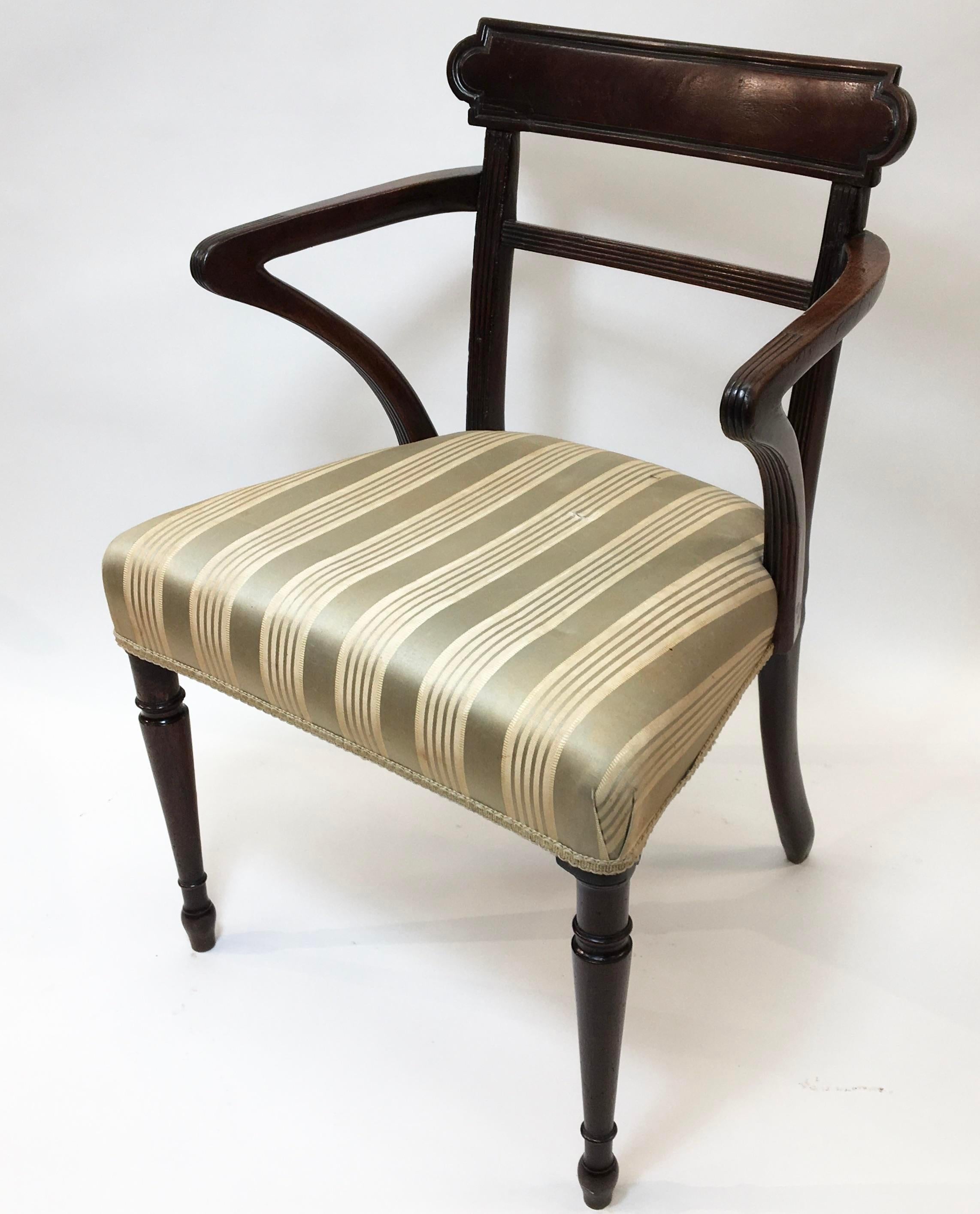 Mahogany Regency arm chair with a striped silk upholstered seat.