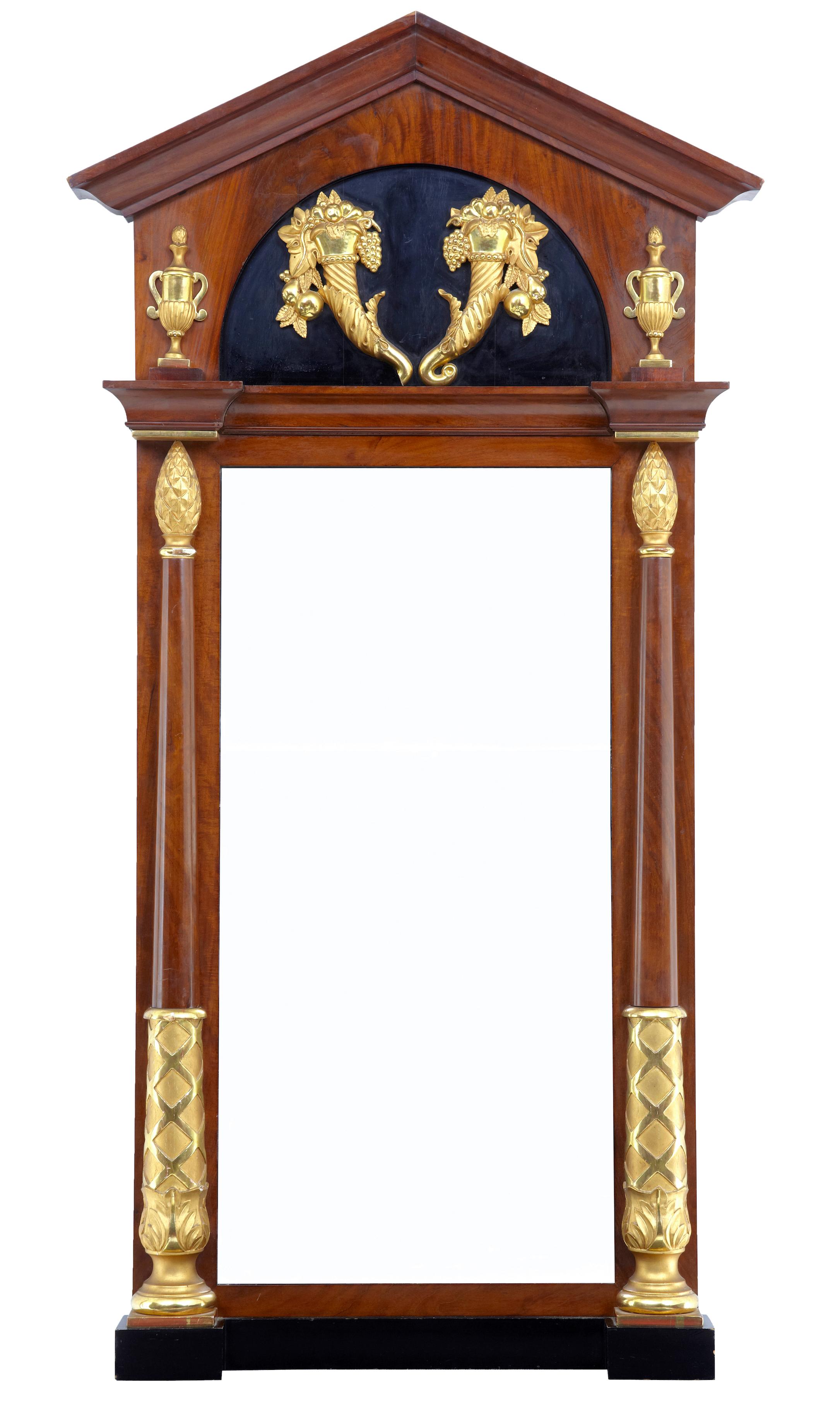 Stunning floor standing mirror.

Featuring carved gilt cornucopia, urns and pineapples. 

Lovely mahogany patina on this 100% original piece. 

Minor loss to one of the cornucopias which can be restored if customer requires.