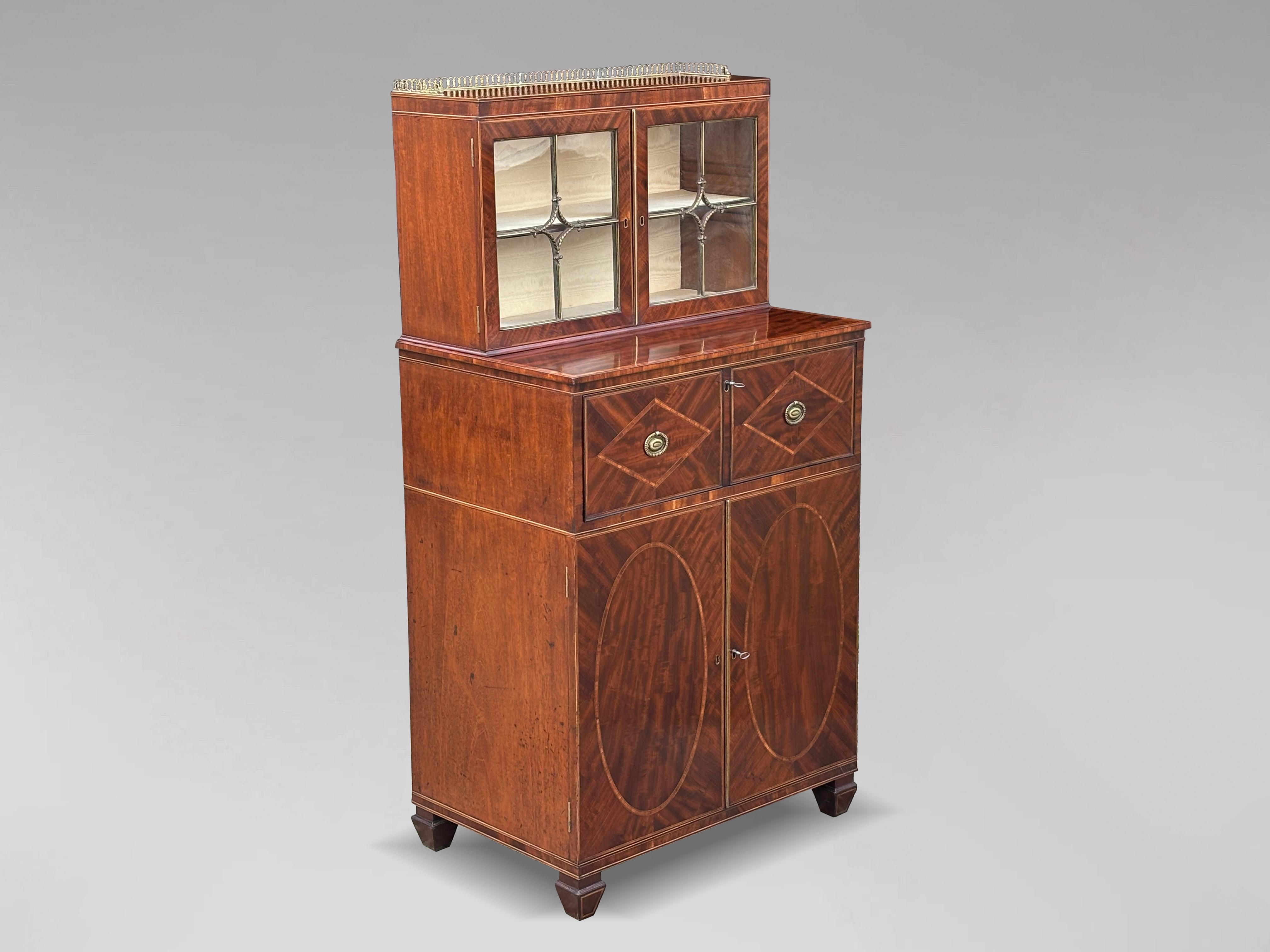 An exceptional fine early 19th century, Regency period brass, mahogany, satinwood and boxwood inlay secretaire bookcase. The upper section with a surmounted by an ornate fretted brass gallery, above a pair of brass astragal glazed doors, enclosing