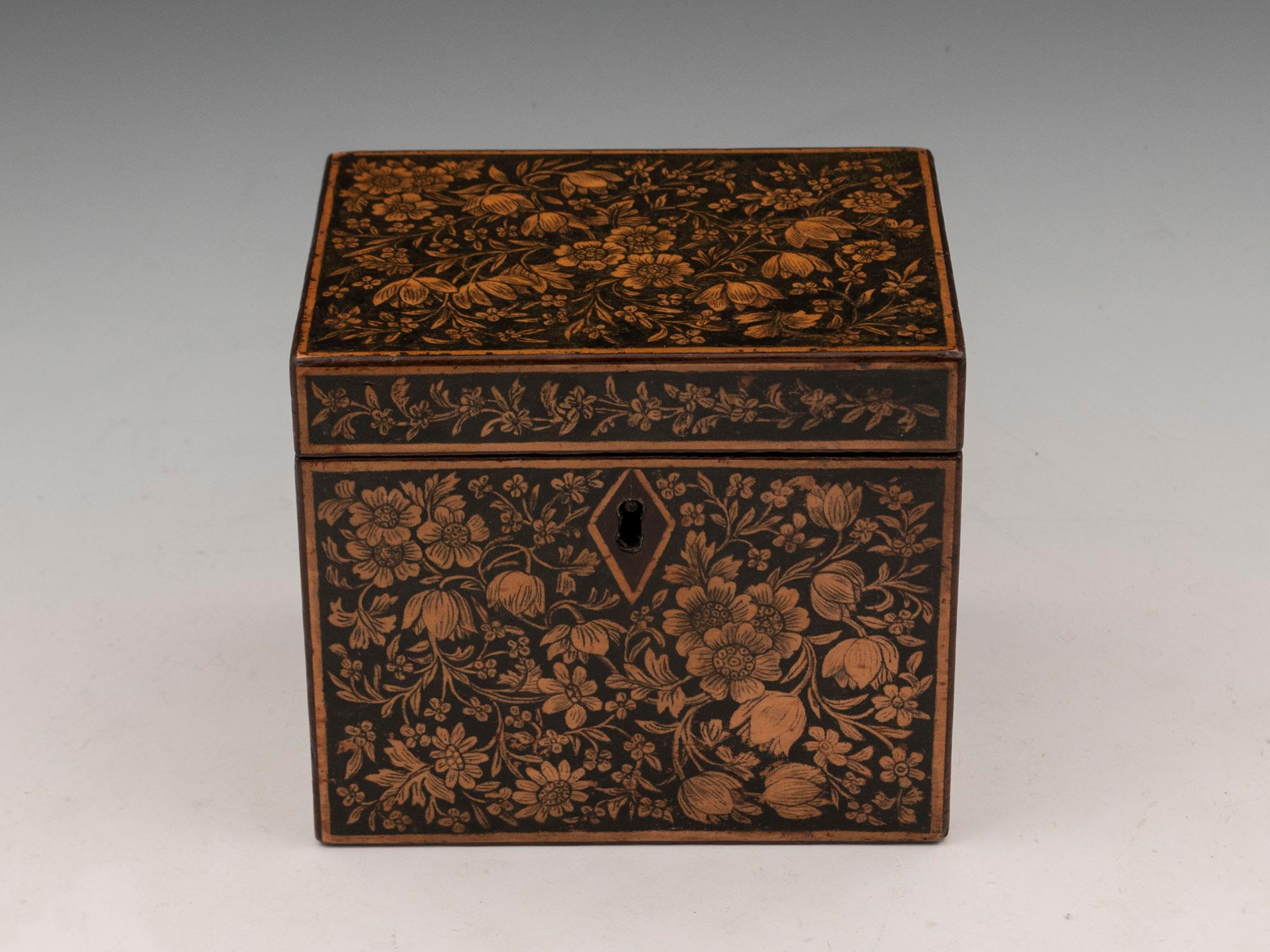 The single penwork tea caddy has a finely detailed floral design adorning all sides which continues inside. It has a single bone handle lid and traces of its original lining.