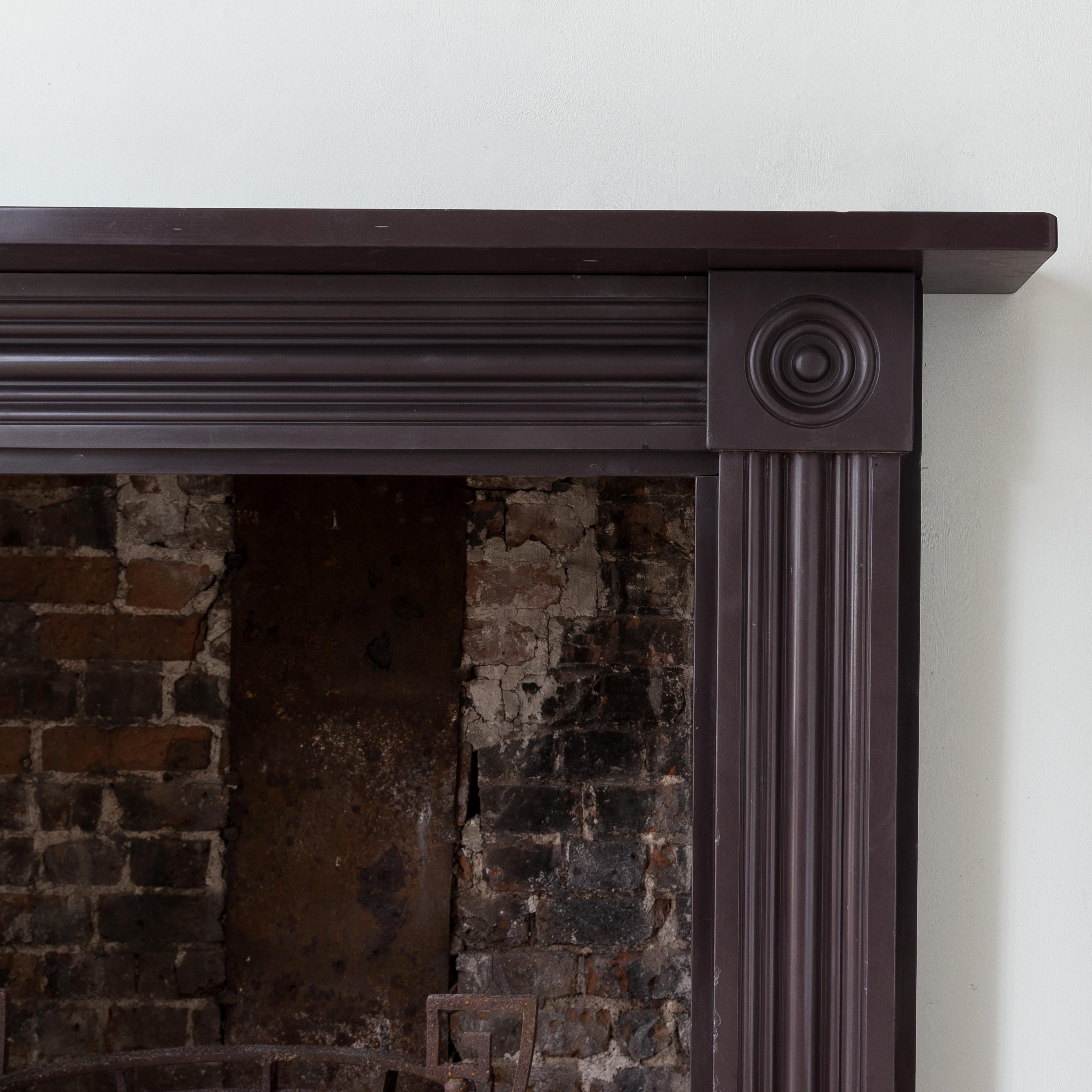 An early nineteenth century Regency slate fireplace, the plain shelf above confidently moulded frieze and jambs, with convex roundel end-blocks.

The opening width is 90.5 cm x 95.5 cm high, and the outside jamb to jamb is 129.5 cm wide.