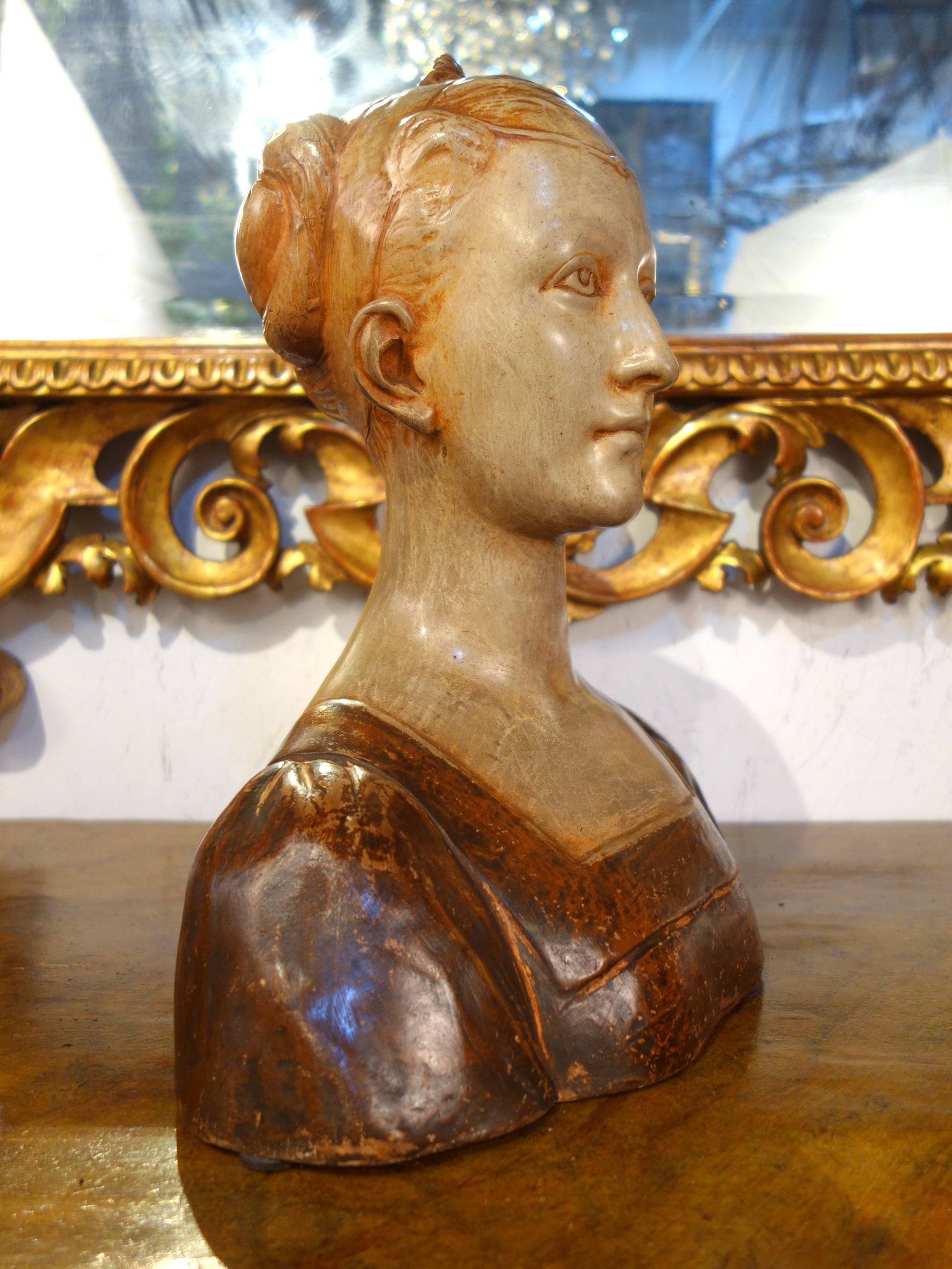 Early 19th century romantic style traditional handcrafted stucco painted like terracotta sculpture, depicting a female half-length portrait. Lovely aged patina, Florence, circa 1820.

Measures: 13.5” W x 15.3” H x 8.5” D.