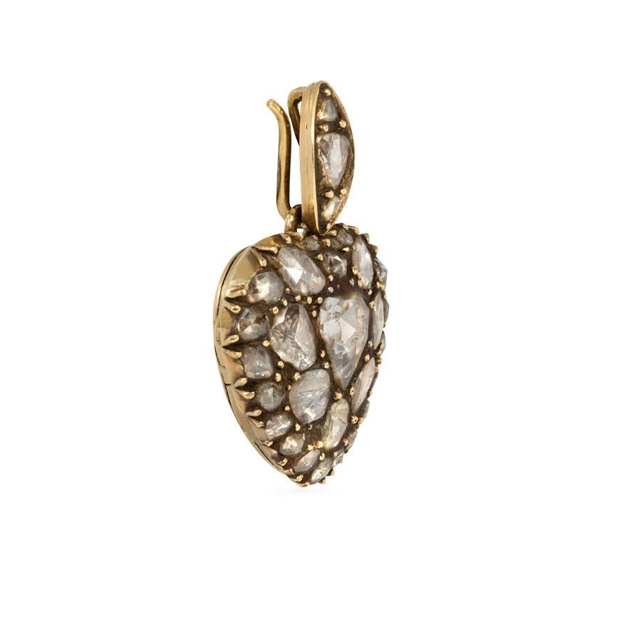 An antique Georgian period heart-shaped locket pendant comprised of brown pavé rose cut diamonds with scrolled foliate engraving on verso, in sterling silver and 18k gold. Original box.  (Chain not included.)