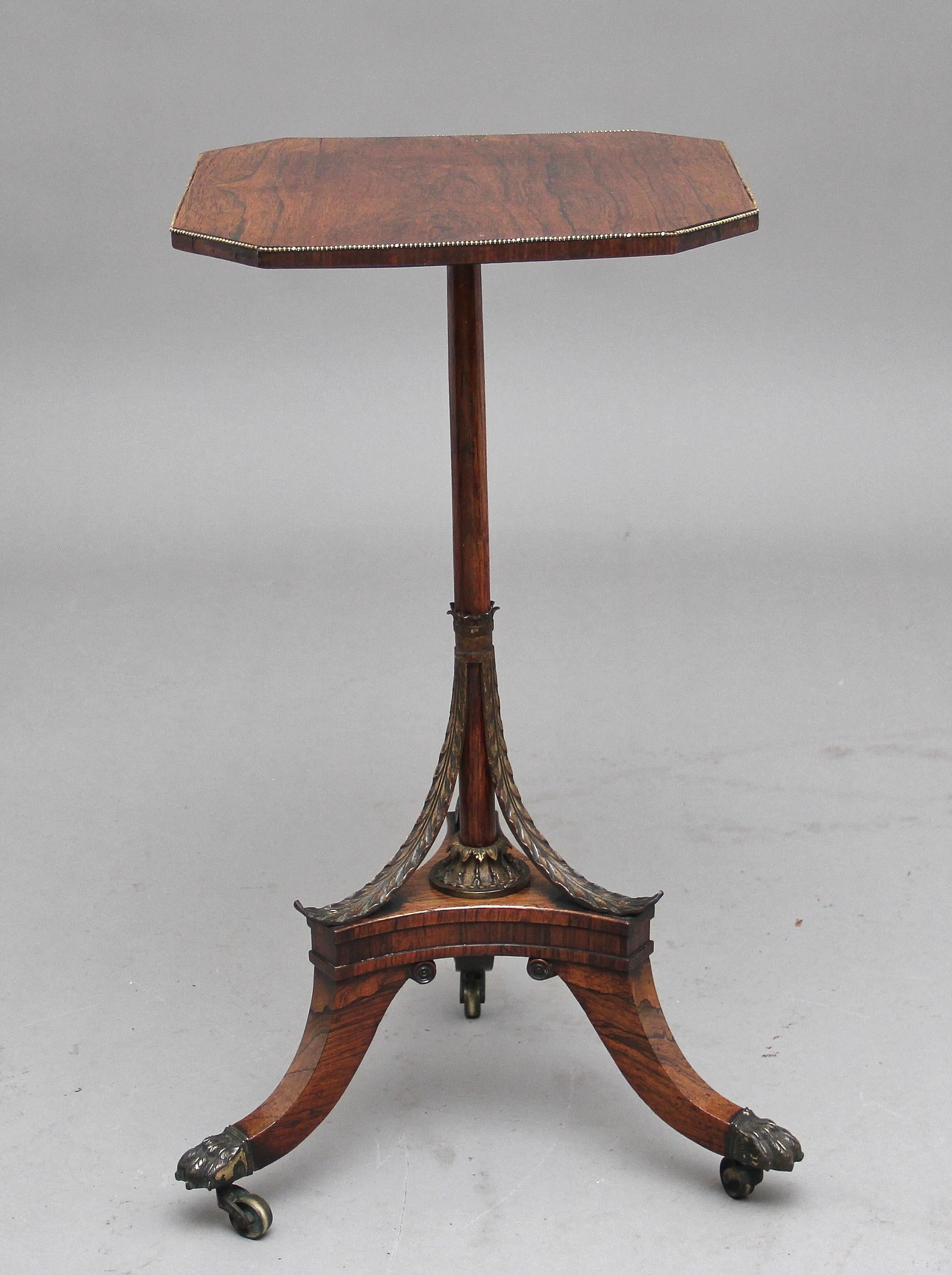 A decorative 19th century rosewood occasional table, having a lovely figured shape top with brass beading around the edge, supported on a finely turned column with gilt metal leaf decoration, tri platform base with three splay legs terminating on