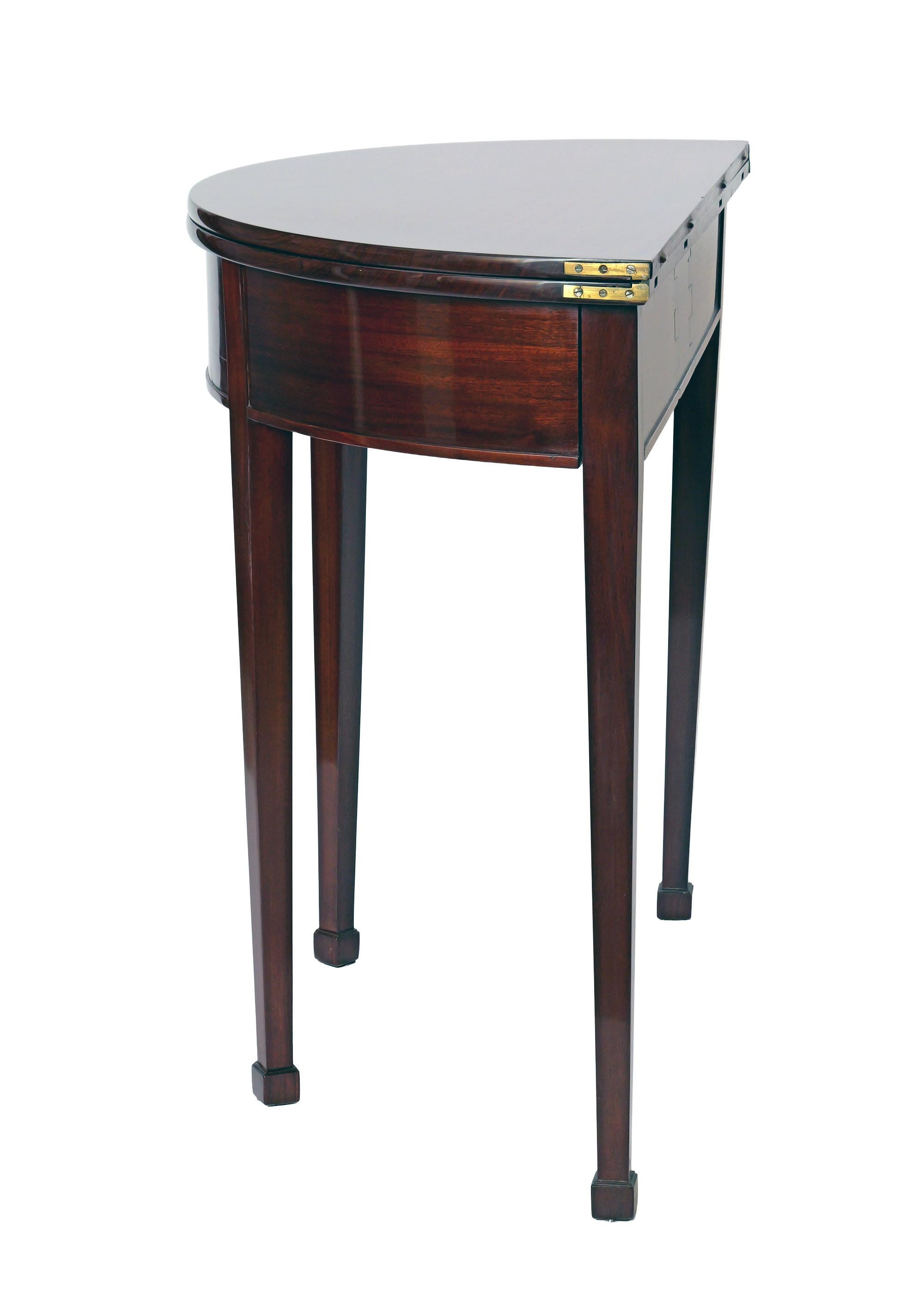 This beautiful early 19th Century Game Table is quite a piece... when folded, it makes for an elegant demi-lune console table, perfect for an entrance way or samller room. When opened, its the perfect game table for 4 people... In a rich mahagony,