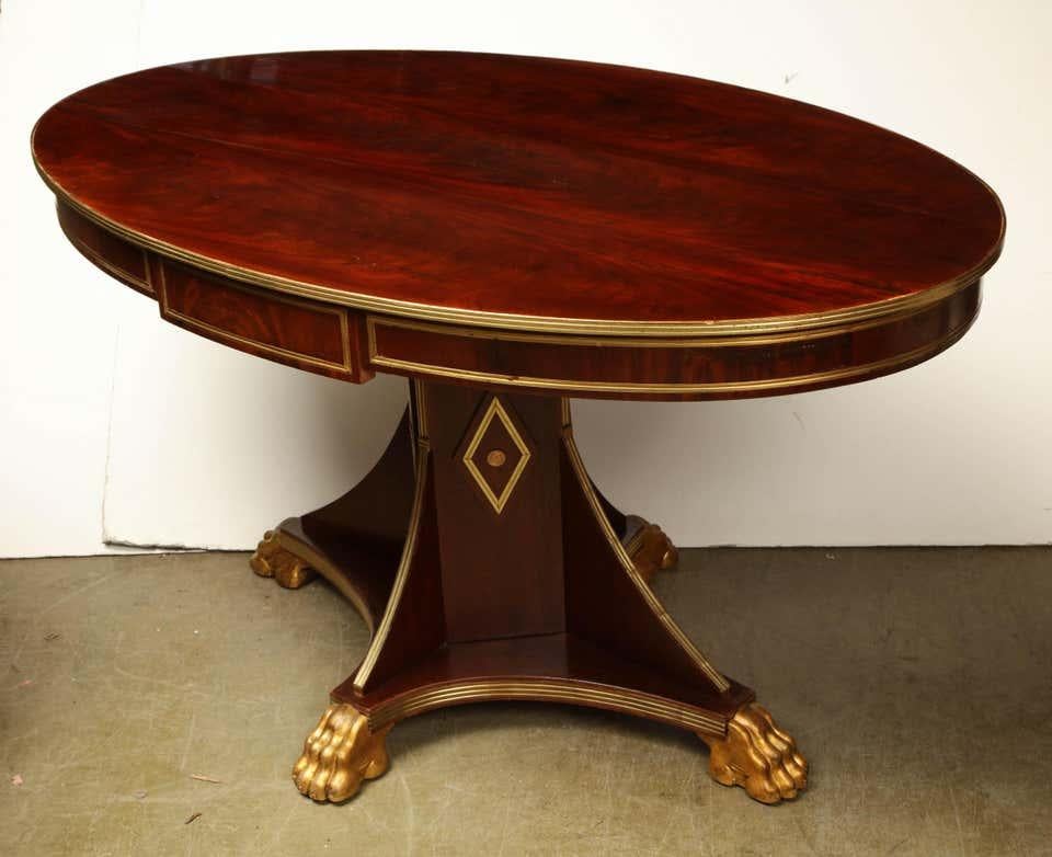 Early 19th century rare Russian mahogany and hand-hammered brass inlayed center hall table with a single drawer.