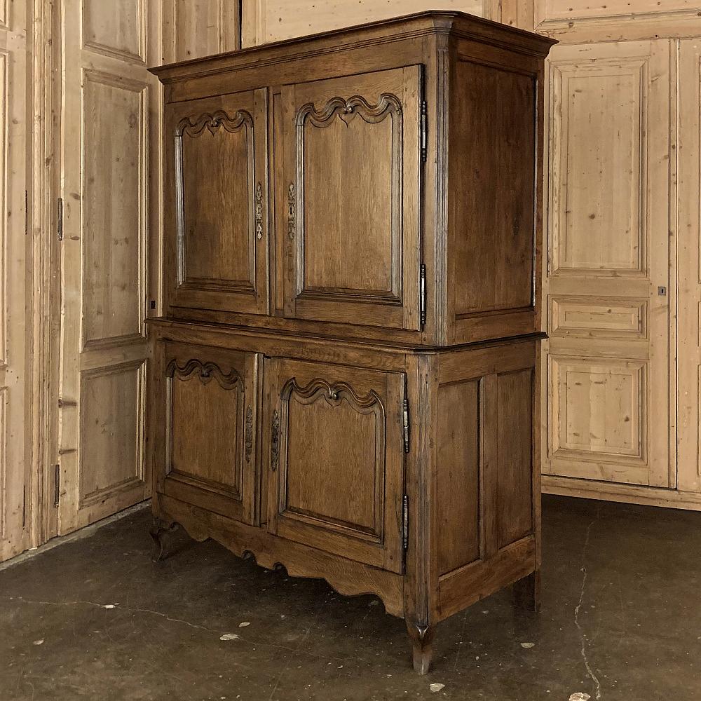 Early 19th century rustic Country French buffet a Deux Corps was designed for storage in style! Hand-crafted from locally obtained old-growth oak, it features pegged mortise & tenon joinery crafted in the traditions handed down for centuries in