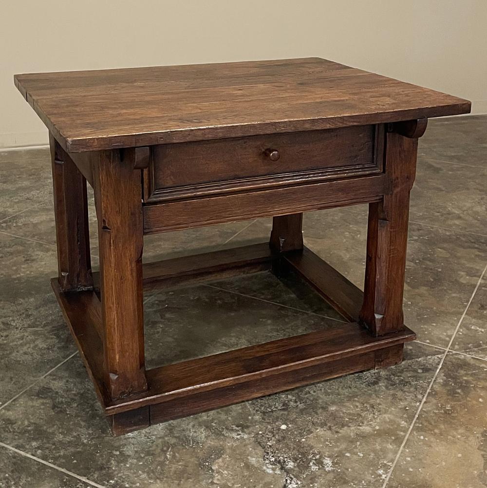 Early 19th century rustic Dutch oak side table was literally designed to last for centuries! Using beams and thick planks of solid, old-growth oak, the artisans created an incredibly sturdy design, with four heavy posts on each corner joined to a